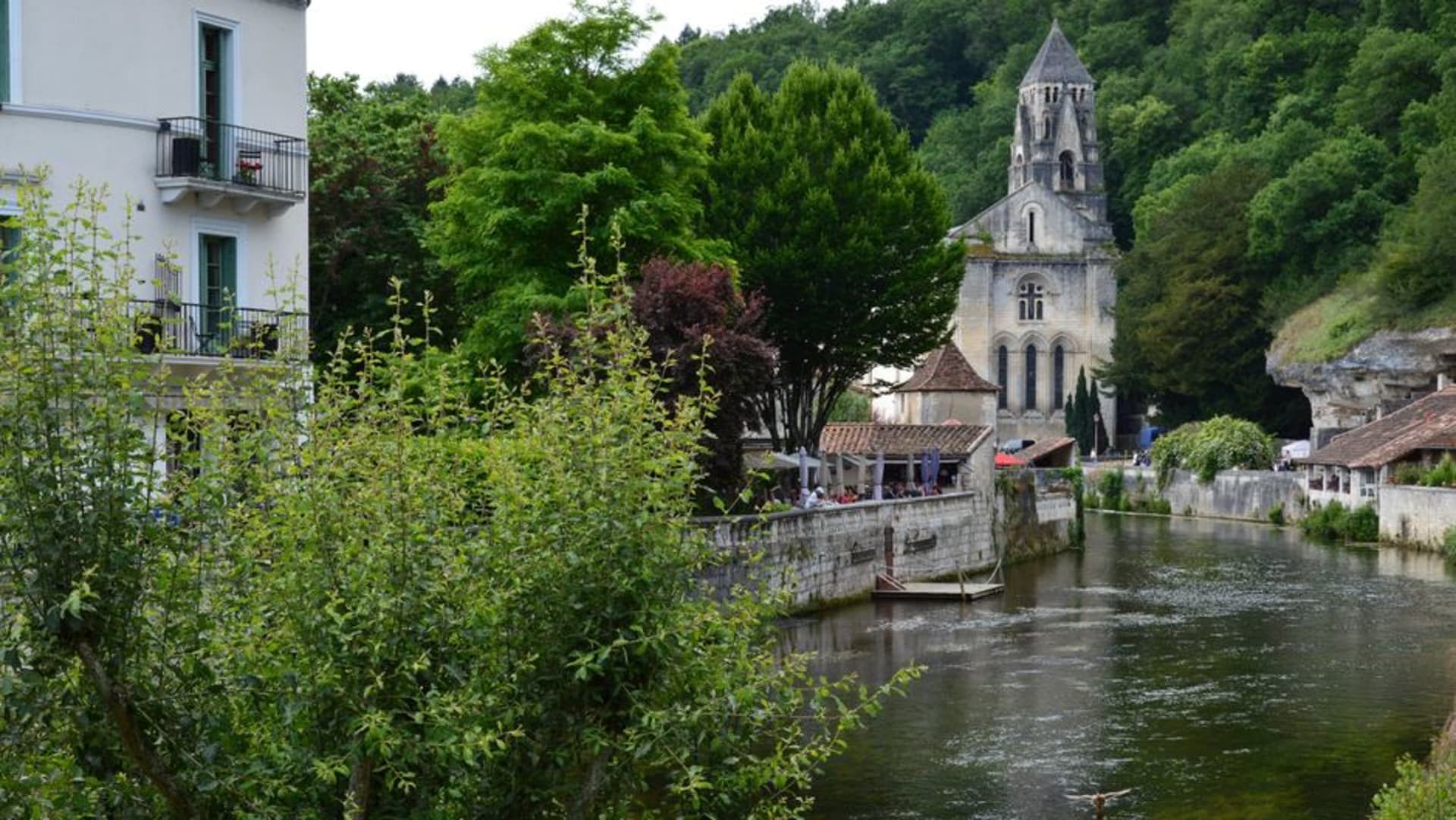The village of Baume-les-Messieurs with its abbey set inside a dead-end limestone canyon ringed by forested cliffs