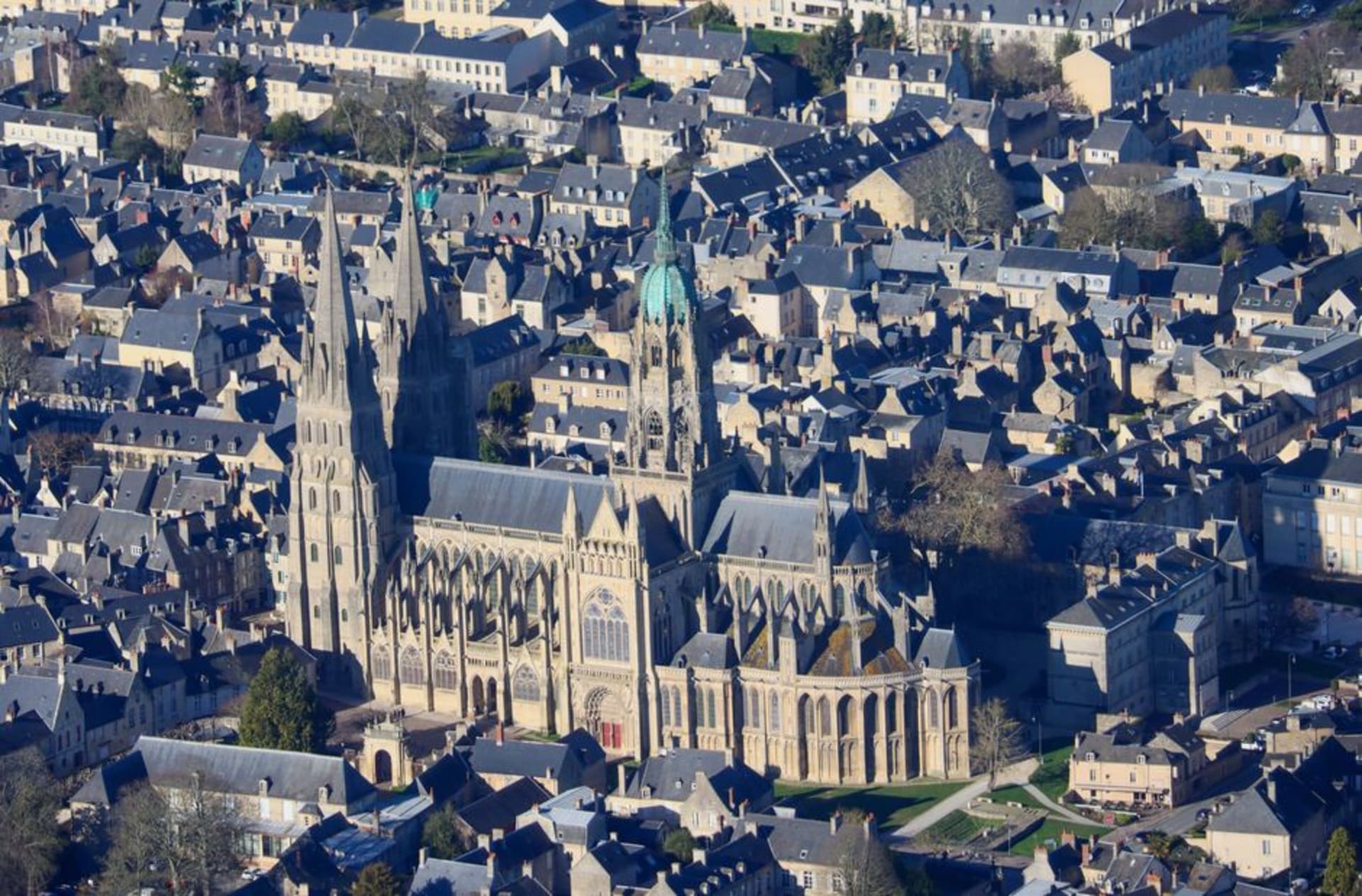 The twin spires of Bayeux Cathedral rising above the town's stone streets and the Aure river