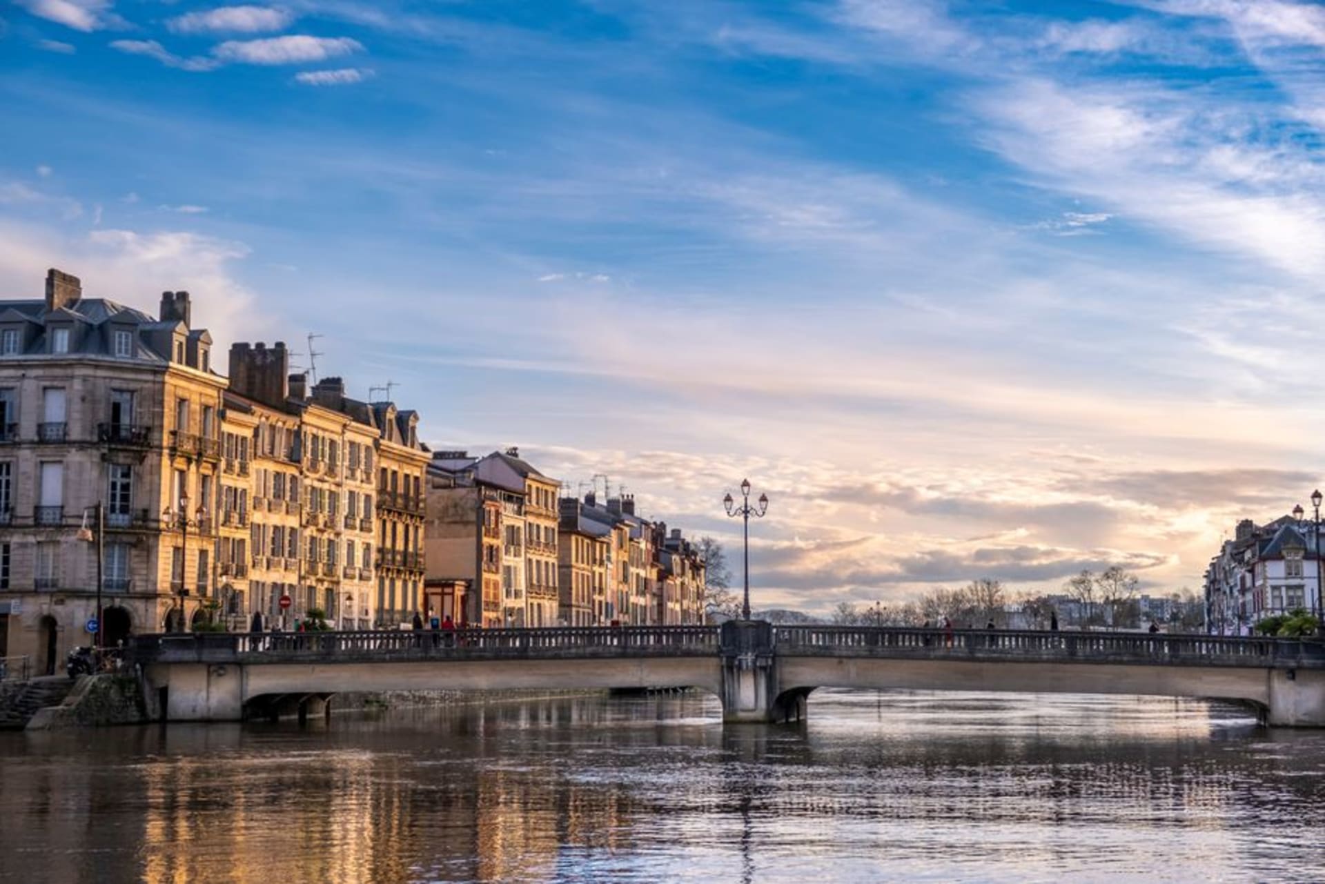 The colorful timber-framed houses of Bayonne's Petit Bayonne district lining the banks of the Nive river