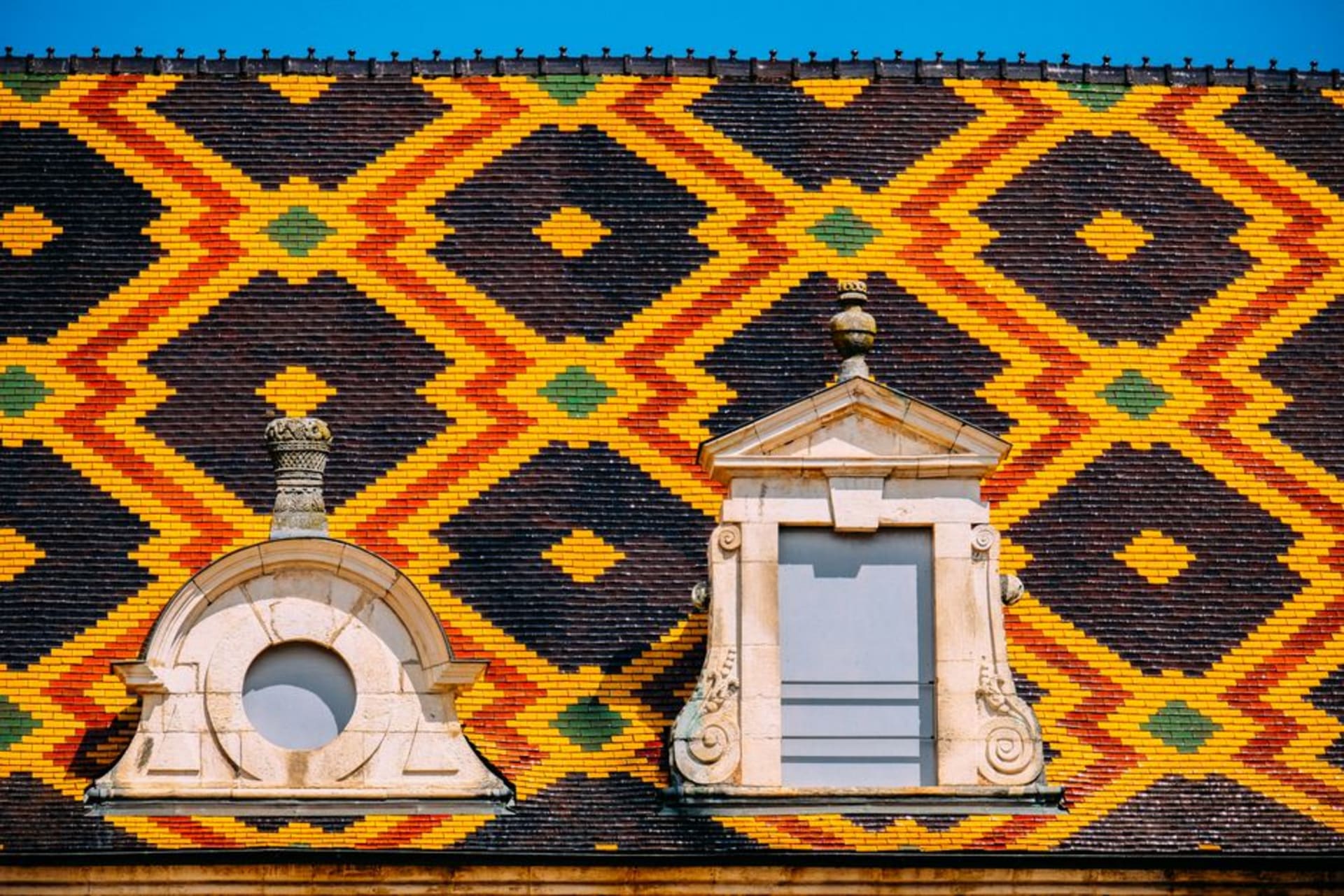 The colourful glazed tile roof pattern of the Hôtel-Dieu in Beaune, Burgundy