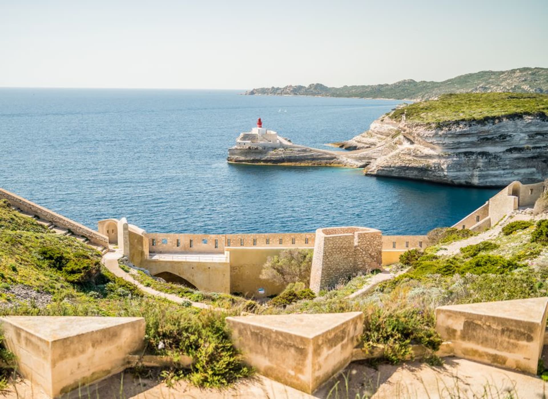 The pale citadel of Bonifacio perched on white limestone cliffs above the Mediterranean at Corsica's southern tip