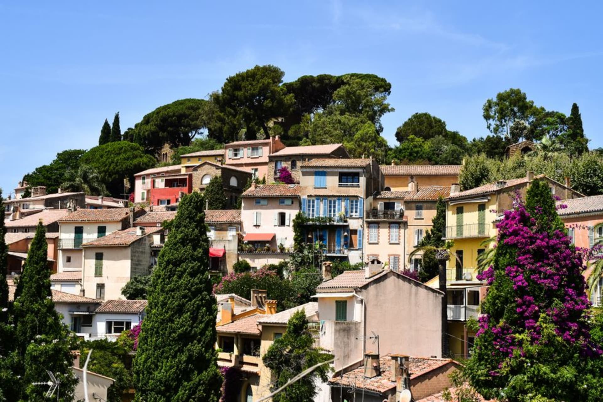 Stone stairways of Bormes-les-Mimosas lined with flowering bougainvillea and climbing up the hillside village
