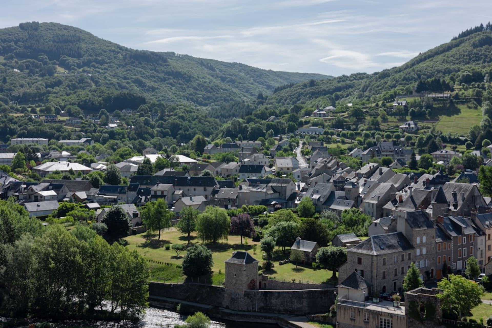 Cargèse's two white churches facing each other across the village square with the sea visible beyond the rooftops