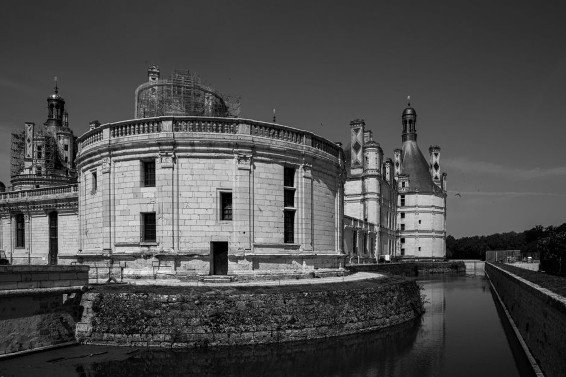 The vast turreted silhouette of the Château de Chambord rising above its moat and the surrounding hunting forest