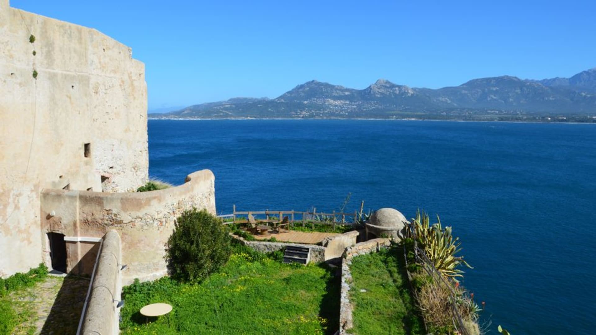 The citadel of Corte perched on a rocky outcrop above the old town, with Corsica's mountains rising behind