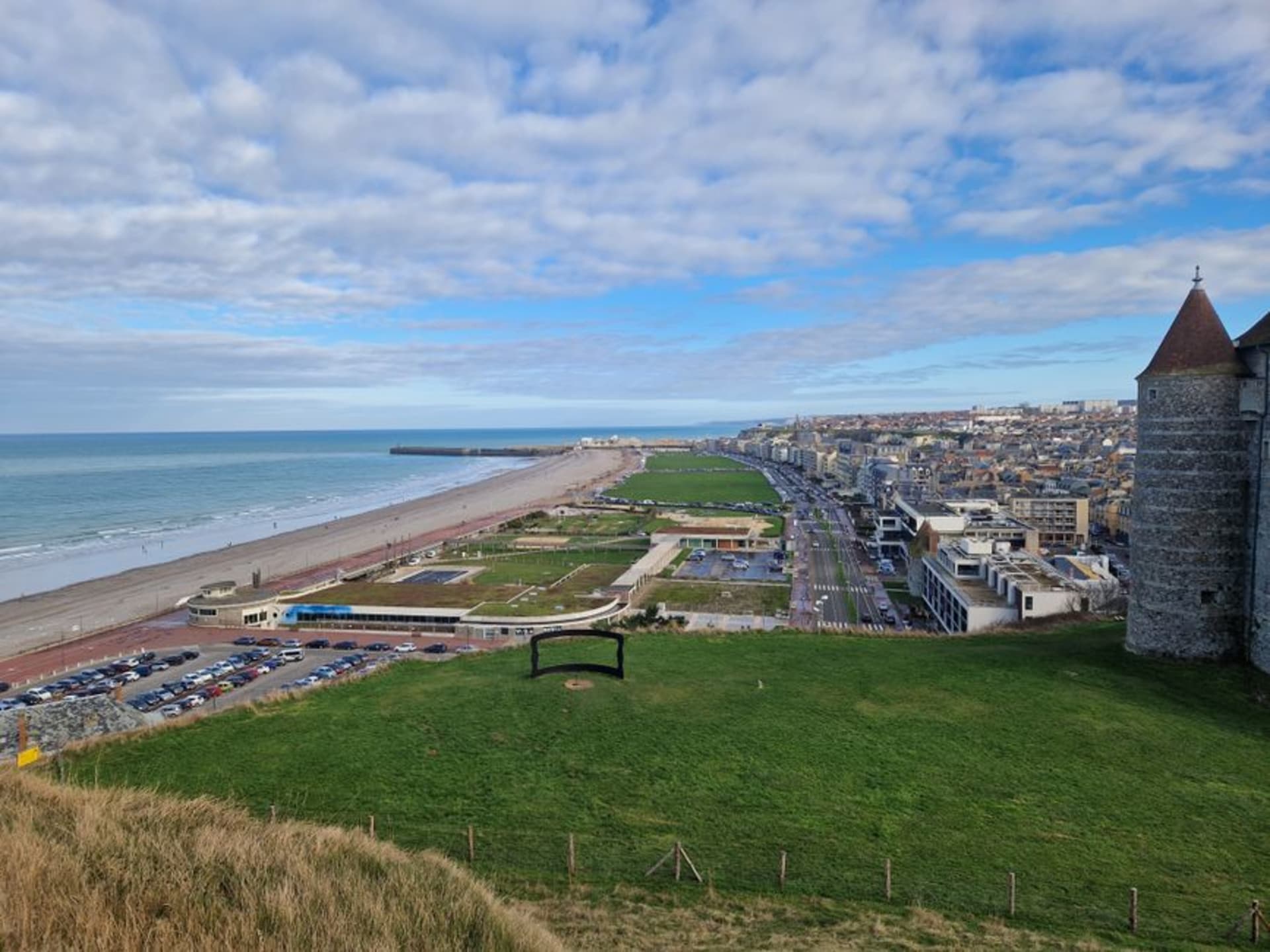 The chalk cliffs and pebble beach of Dieppe with the castle-museum standing on the headland above town