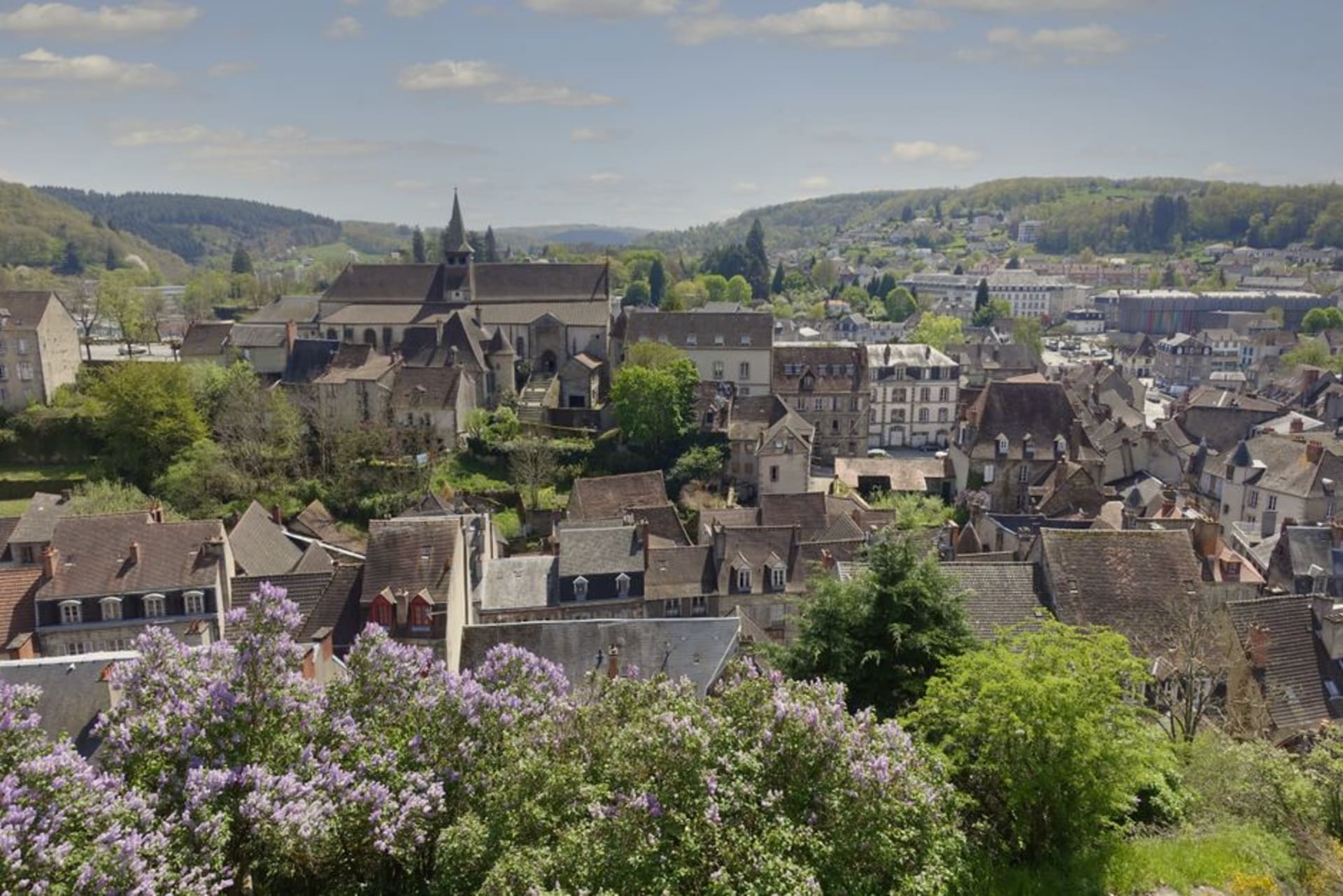 Medieval half-timbered merchant houses lining a narrow stone street in the old town of Figeac