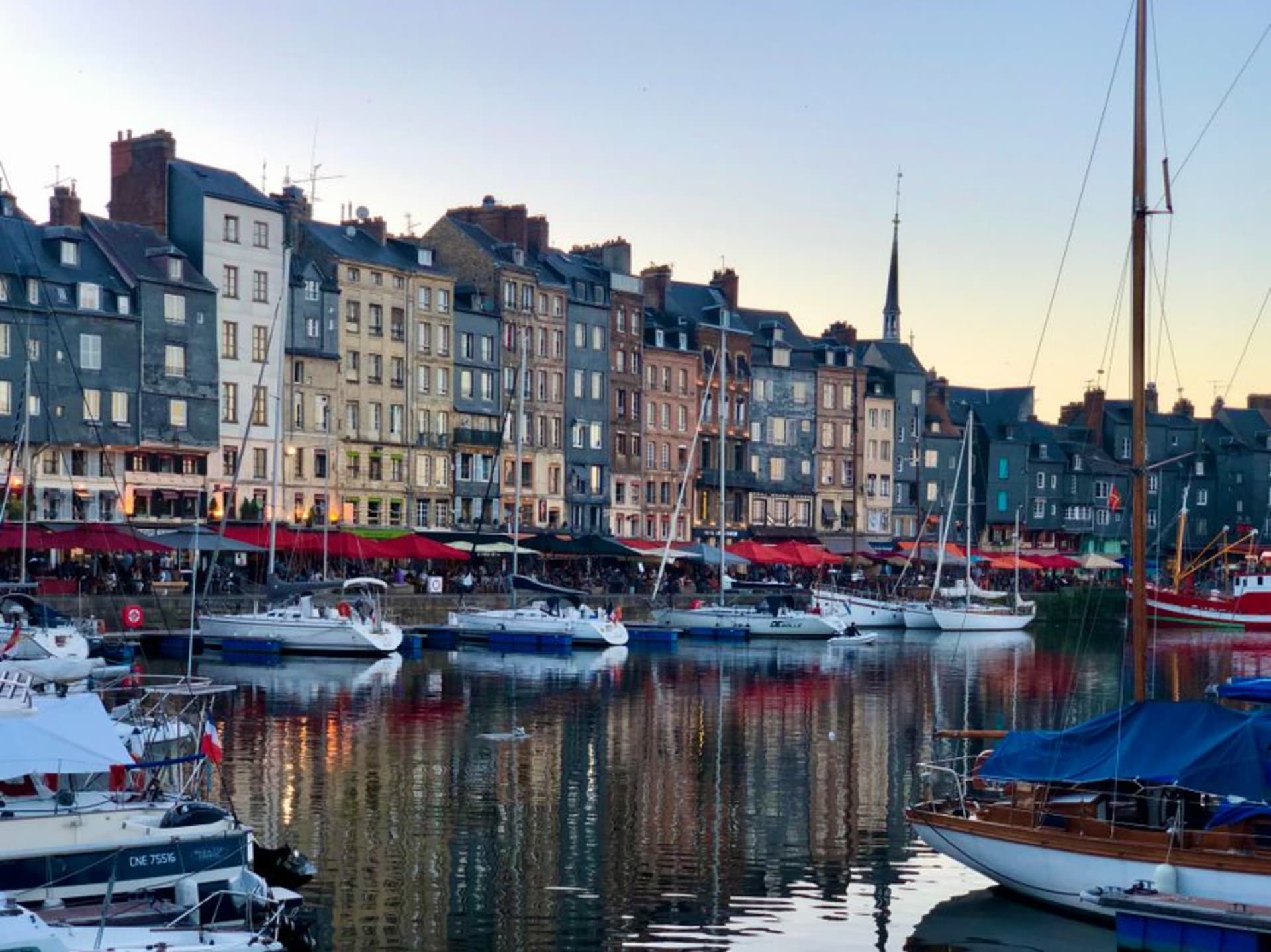 The Vieux Bassin harbour of Honfleur lined with tall narrow slate-fronted houses and moored sailboats