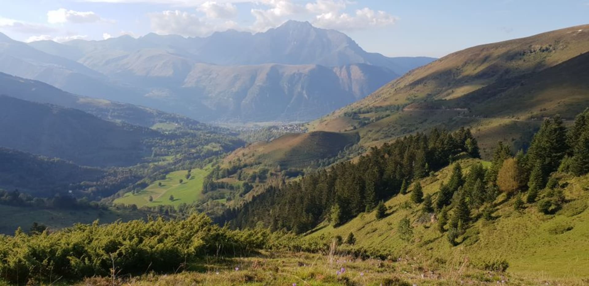 The village of Laruns nestled at the mouth of the Ossau valley with the road climbing toward the Col d'Aubisque behind it