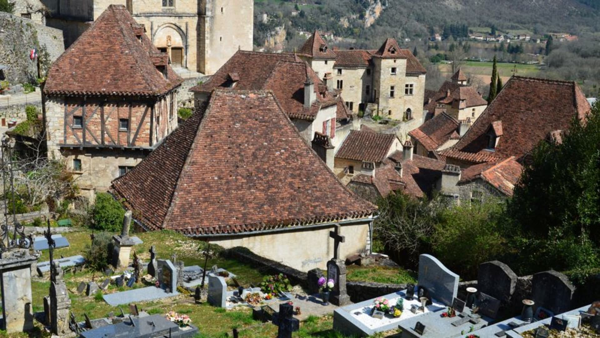 The medieval stone towers of Martel rising above the market square rooftops in the Quercy countryside