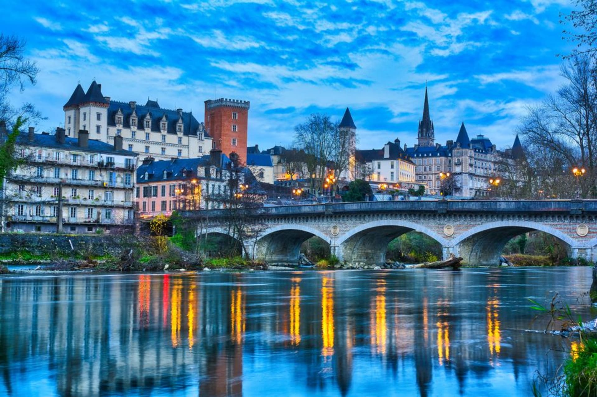 The Château de Pau overlooking the Gave de Pau river with the snow-capped Pyrenees visible in the far distance