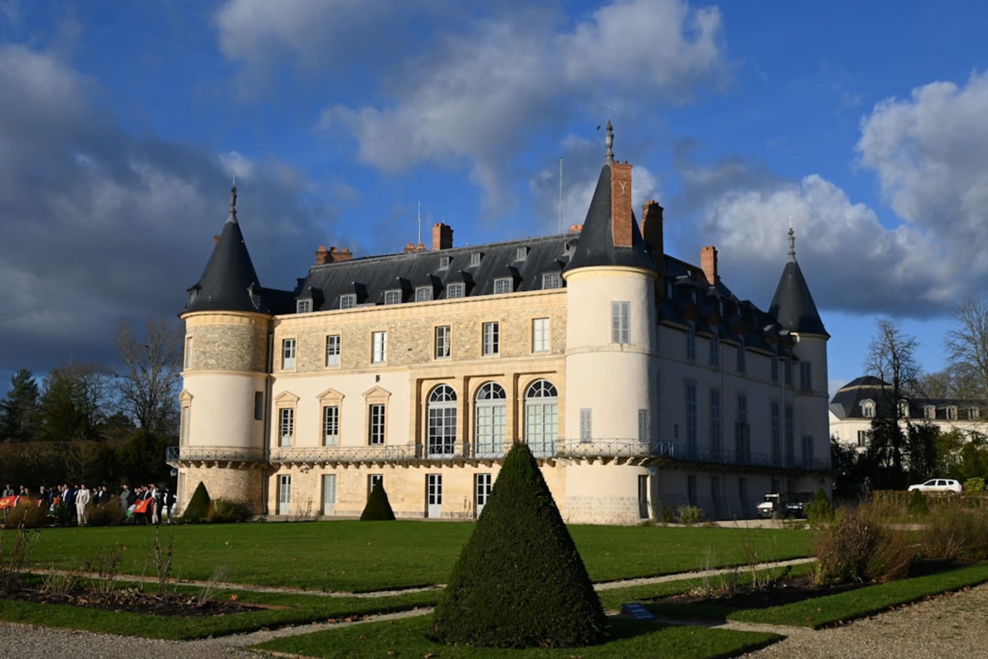 The moated château of Rambouillet with its round medieval tower reflected in the surrounding water
