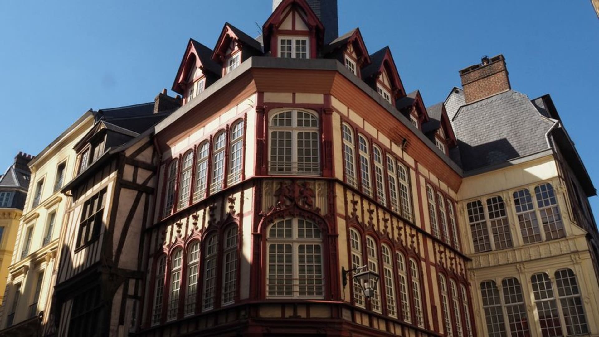 The colourful leaning half-timbered houses of Place Sainte-Anne in Rennes at dusk