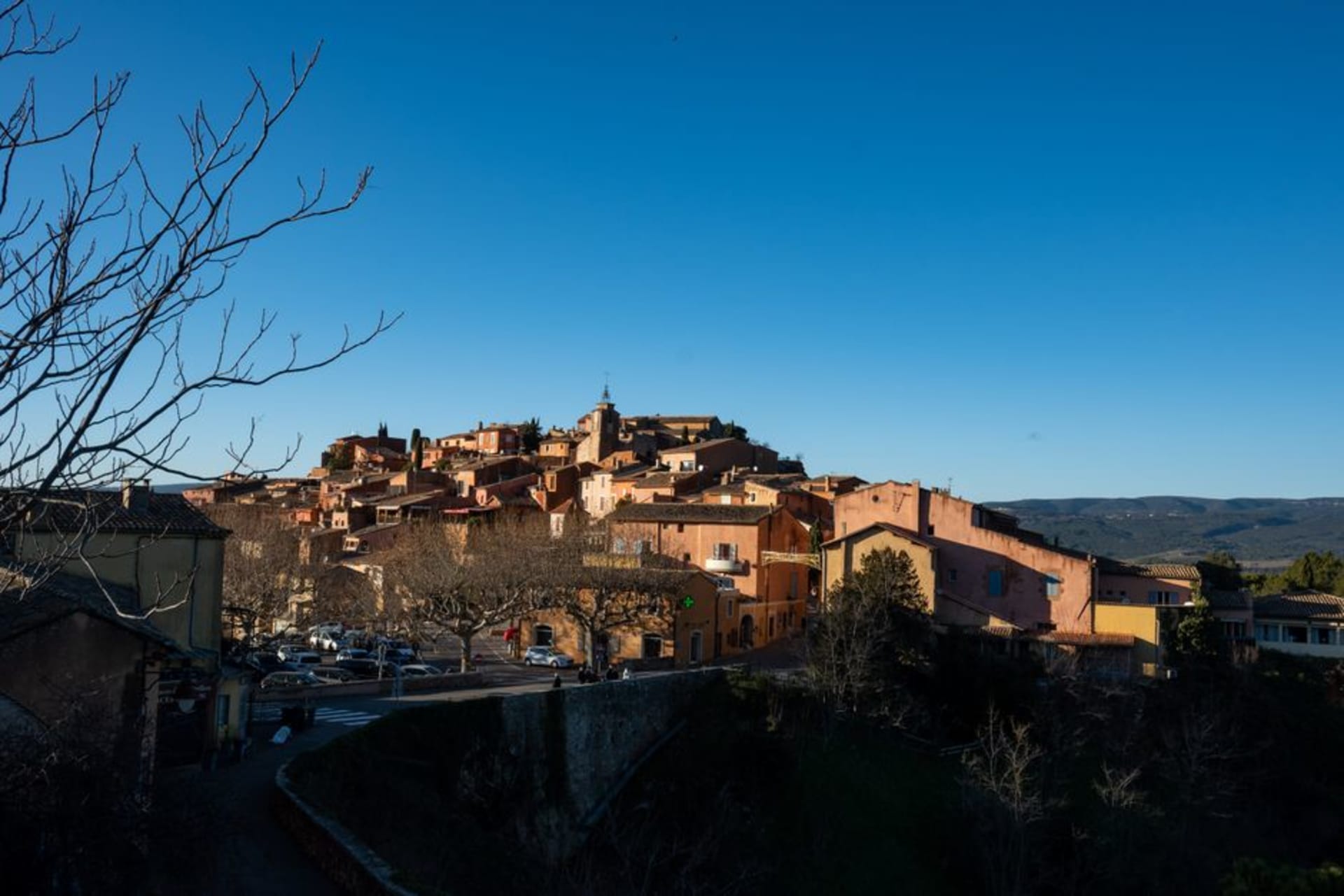 The ochre-red cliffs and rust-coloured houses of Roussillon village in the Luberon