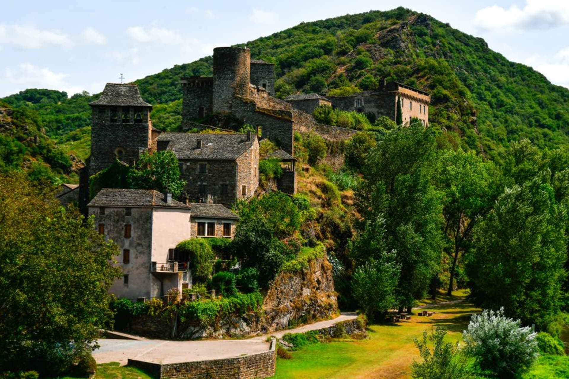 The dark volcanic stone towers and turreted houses of the fortified village of Salers in the Cantal highlands
