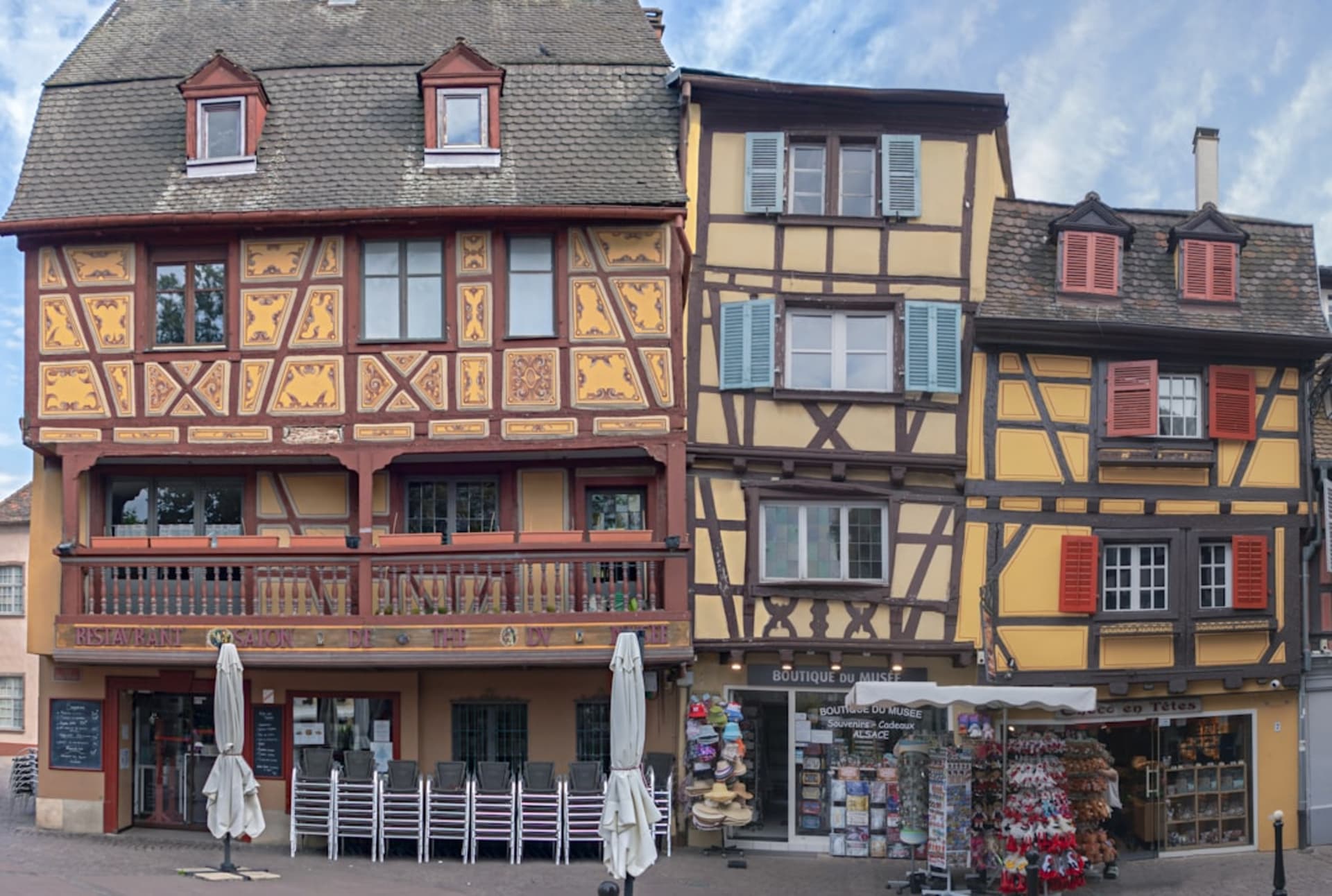 The half-timbered houses of Place Plumereau in Tours' old town, cafe terraces filling the square in the evening light