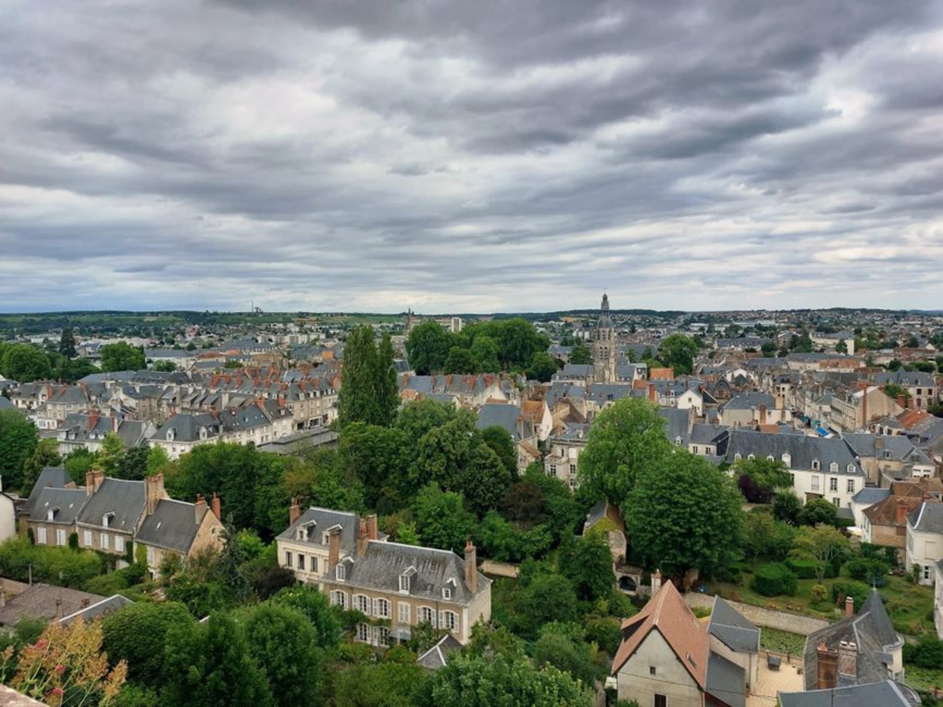 The Gothic bell tower of the Abbaye de la Trinité rising above the rooftops of Vendôme beside the Loir River