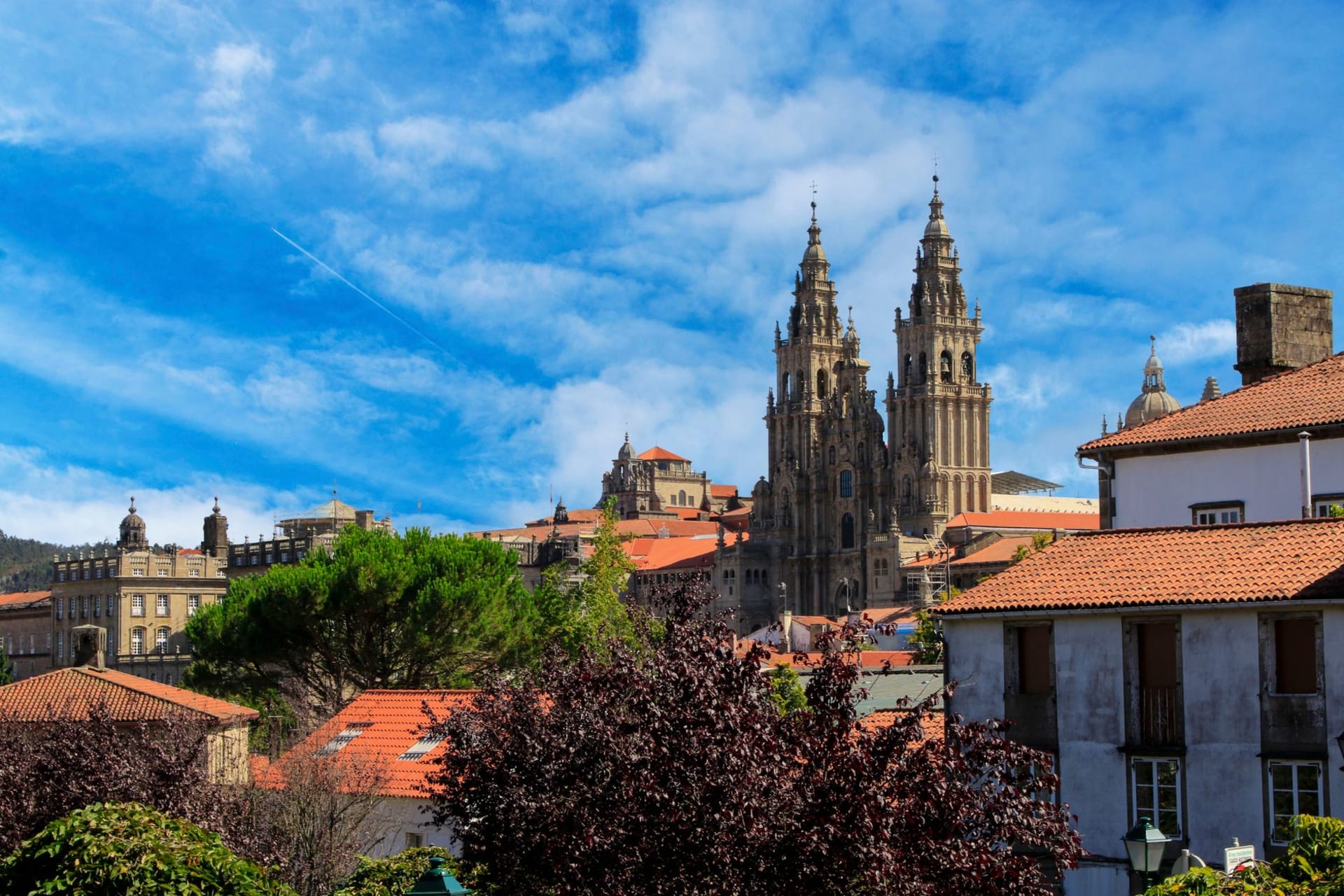 Stone streets and medieval cathedral towers of Santiago de Compostela rising through morning mist