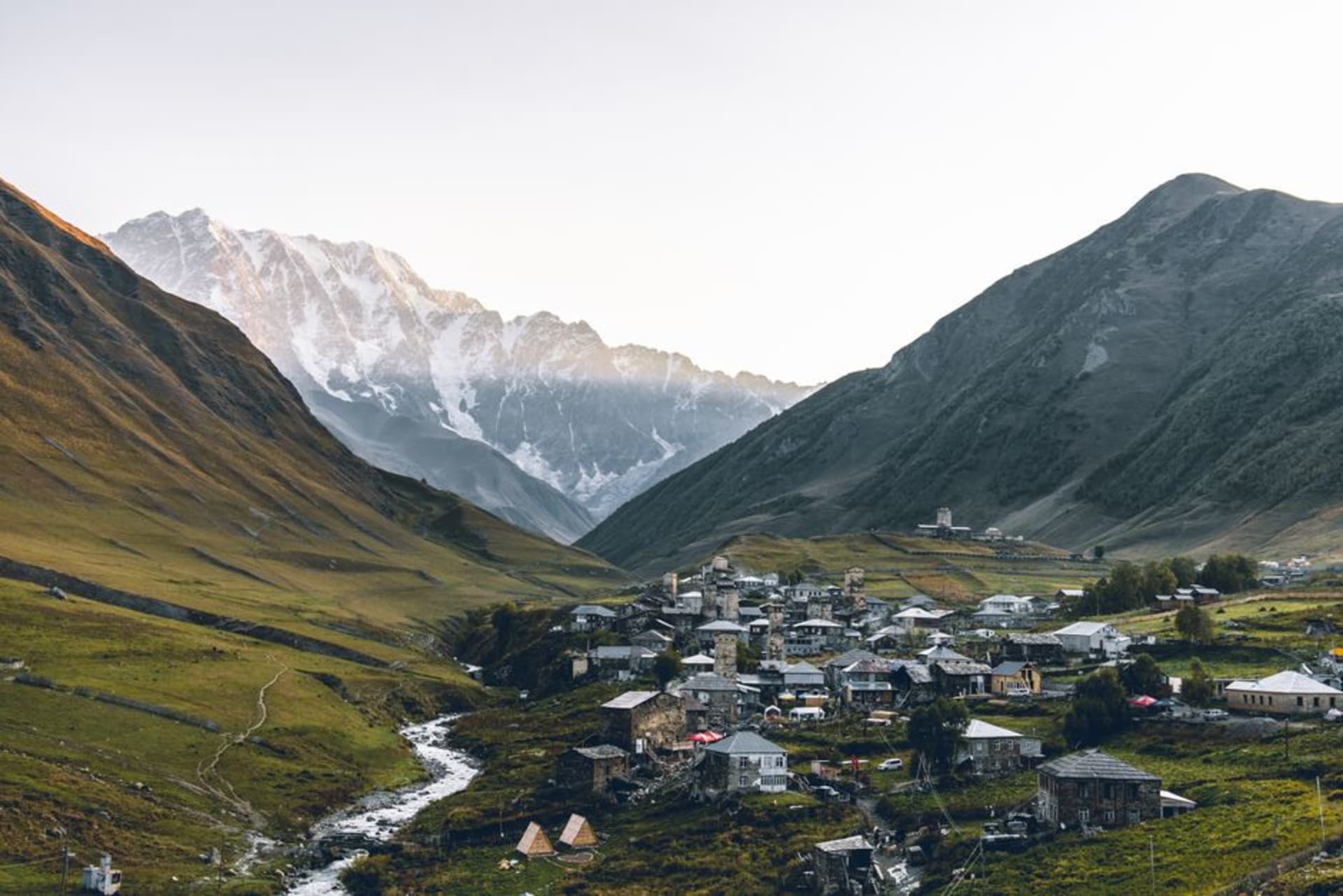 Stone Svan defensive towers in Ushguli with Mount Shkhara rising behind the village