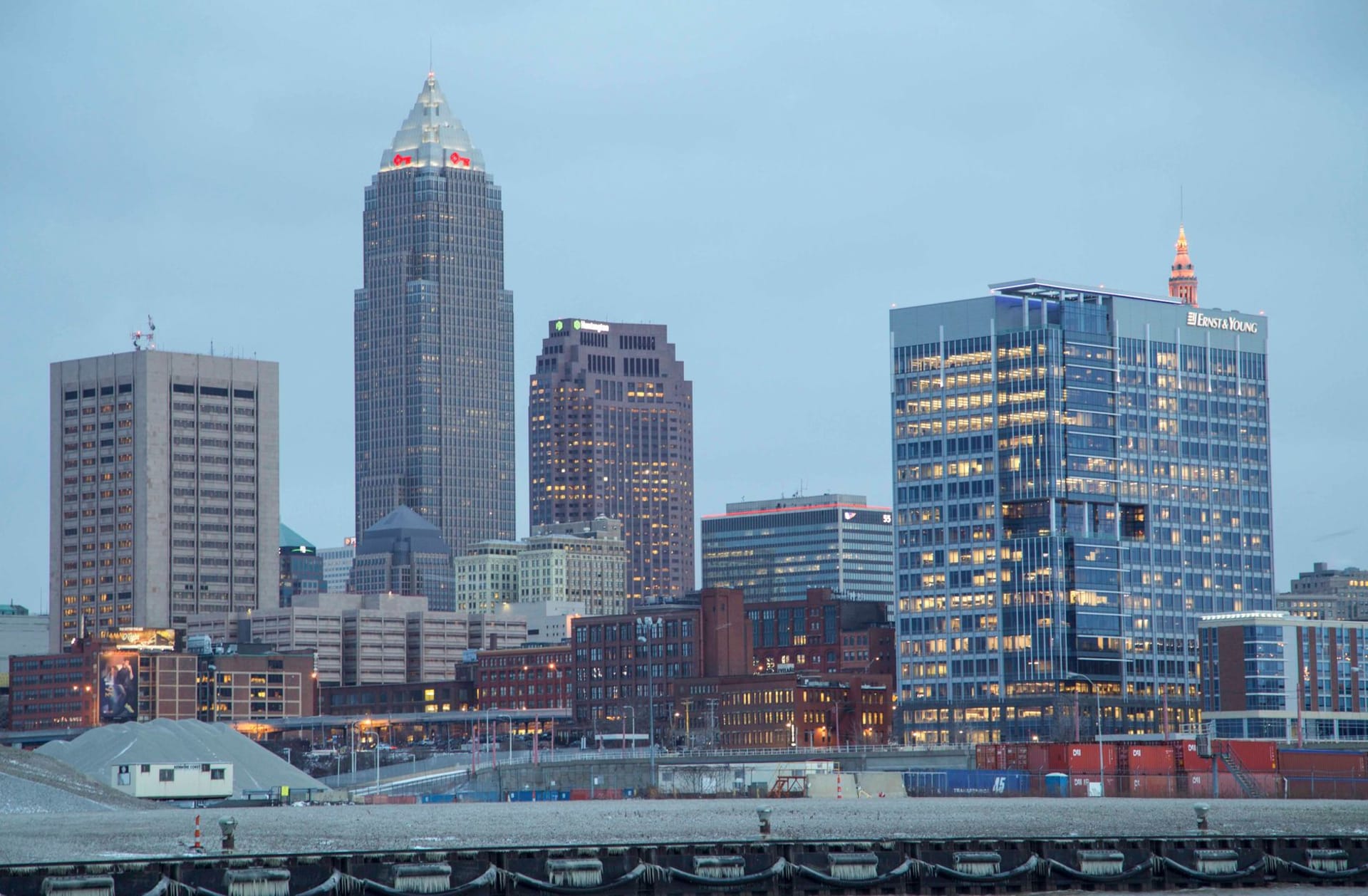 Cleveland's skyline reflected in Lake Erie at dusk, the Rock and Roll Hall of Fame's glass pyramid lit from within in the foreground