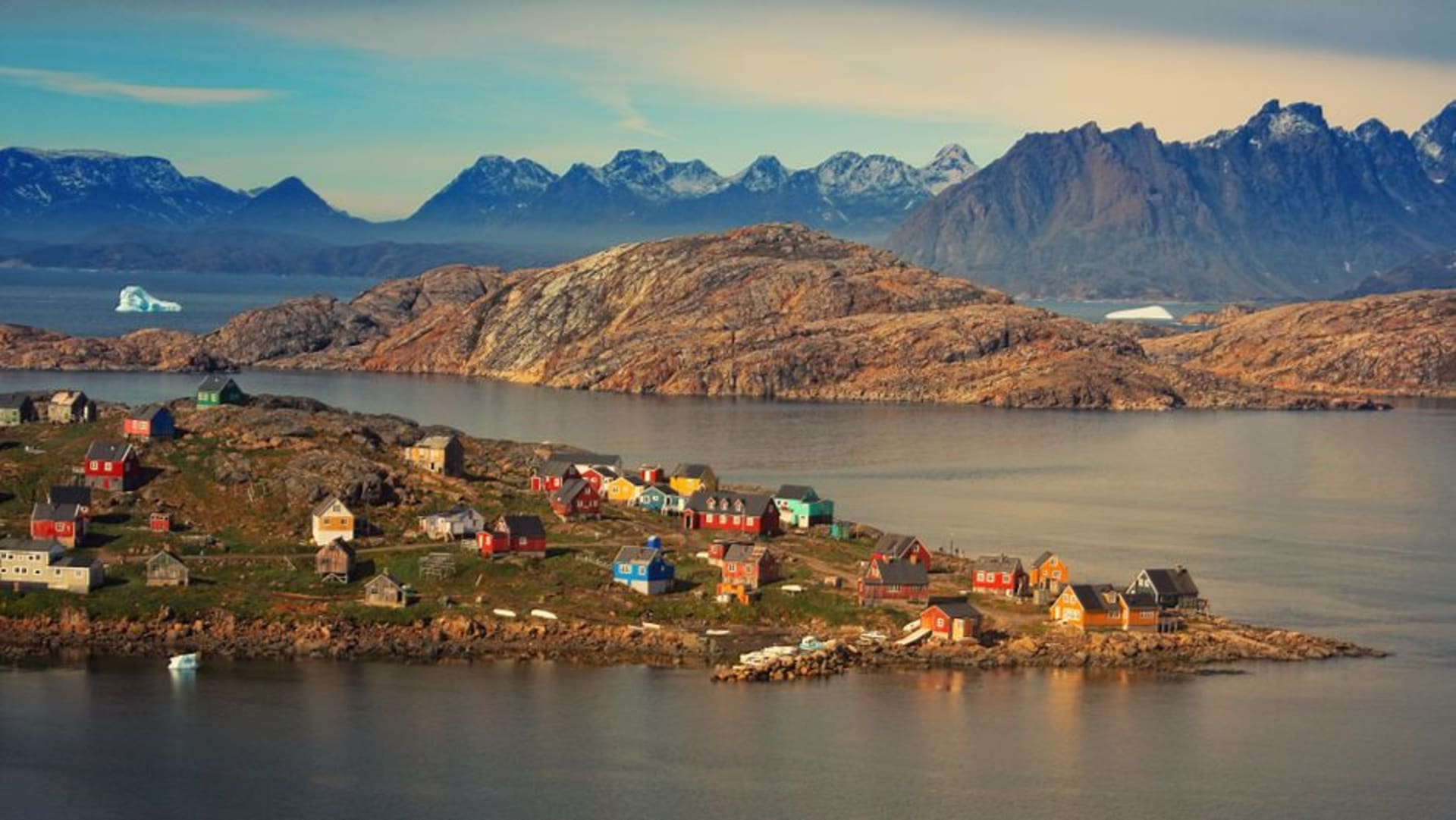 Colorful houses of Kulusuk village overlooking the icy fjord in East Greenland