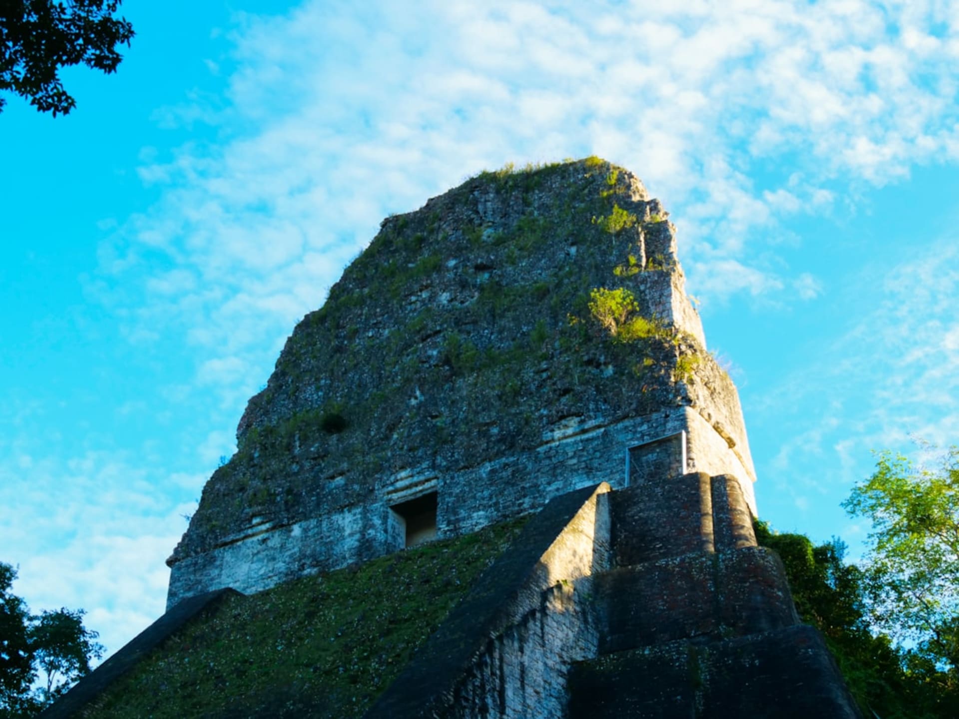 Grass-covered Maya mound at the Kaminaljuyú archaeological park surrounded by Guatemala City