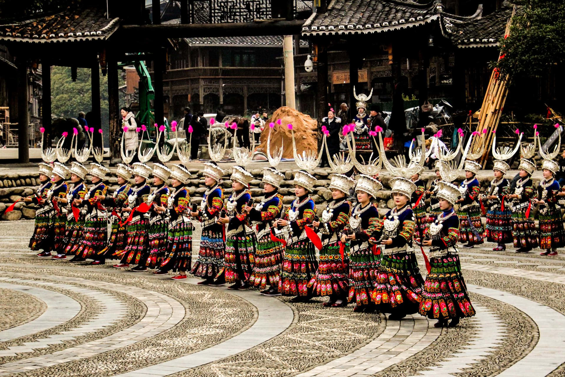 Miao women in elaborate silver headdresses at a festival market in Kaili, Guizhou