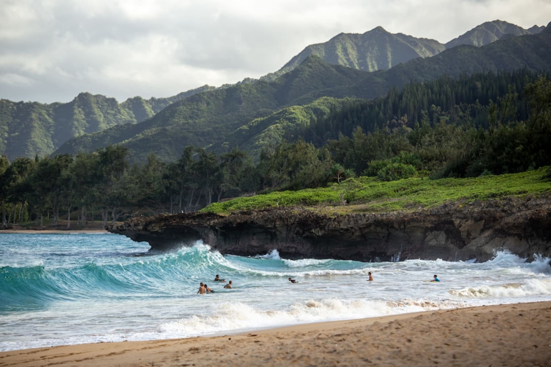 Laguna de Ke'e Beach con un arrecife protector y los acantilados verdes de la costa de Nā Pali elevándose detrás.