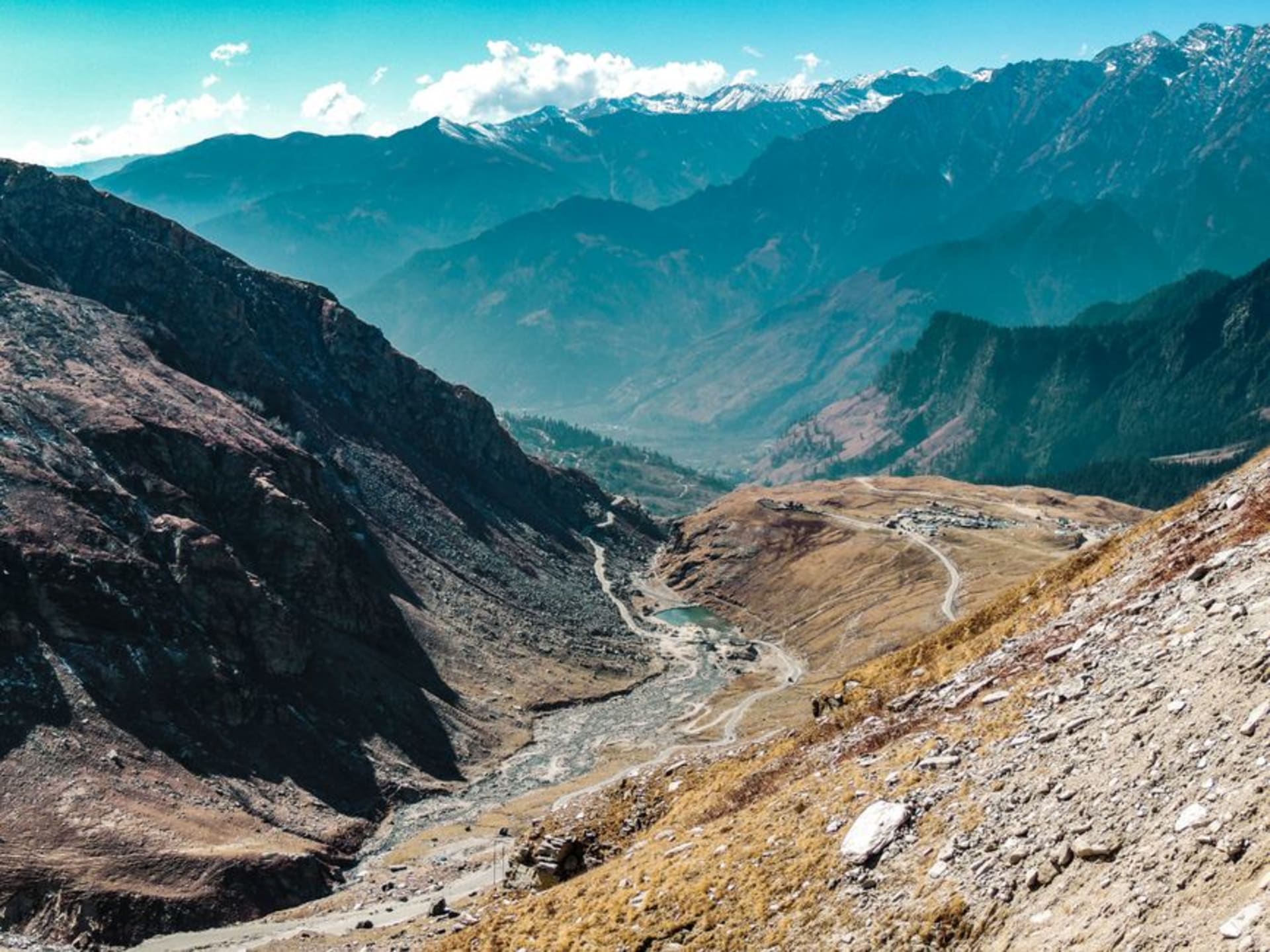 Wooden houses of Chitkul village with mountains rising above the Baspa River
