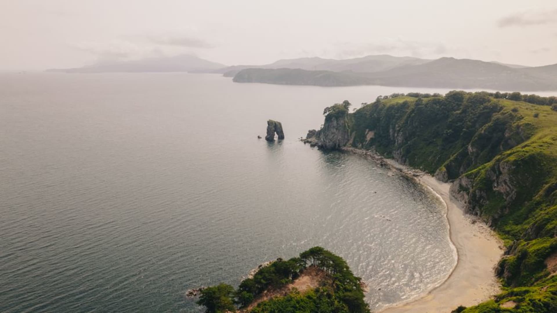 Cape Kamui on the Shakotan Peninsula, a narrow rocky ridge trail leading out to a lighthouse above intensely blue water
