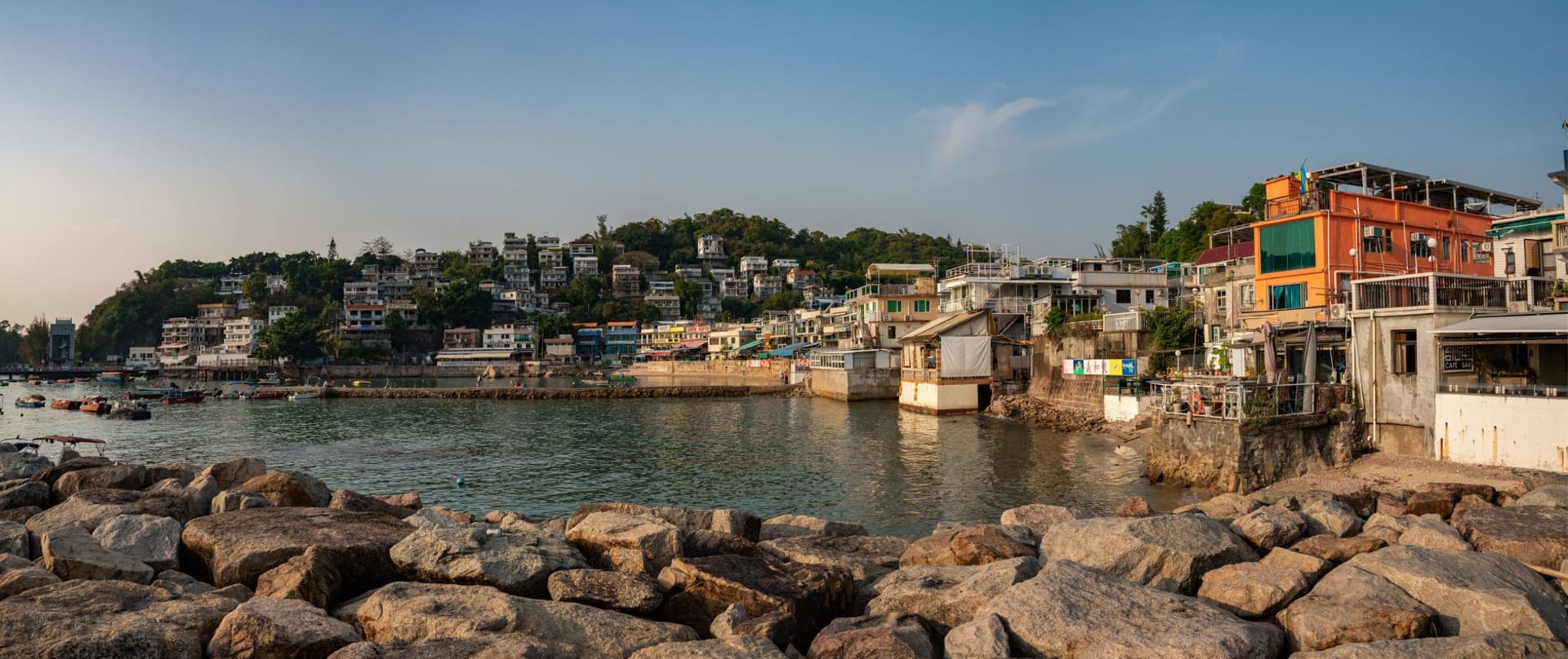 Open-air seafood restaurants along the Lamma Island waterfront at Sok Kwu Wan, lanterns lit in the evening