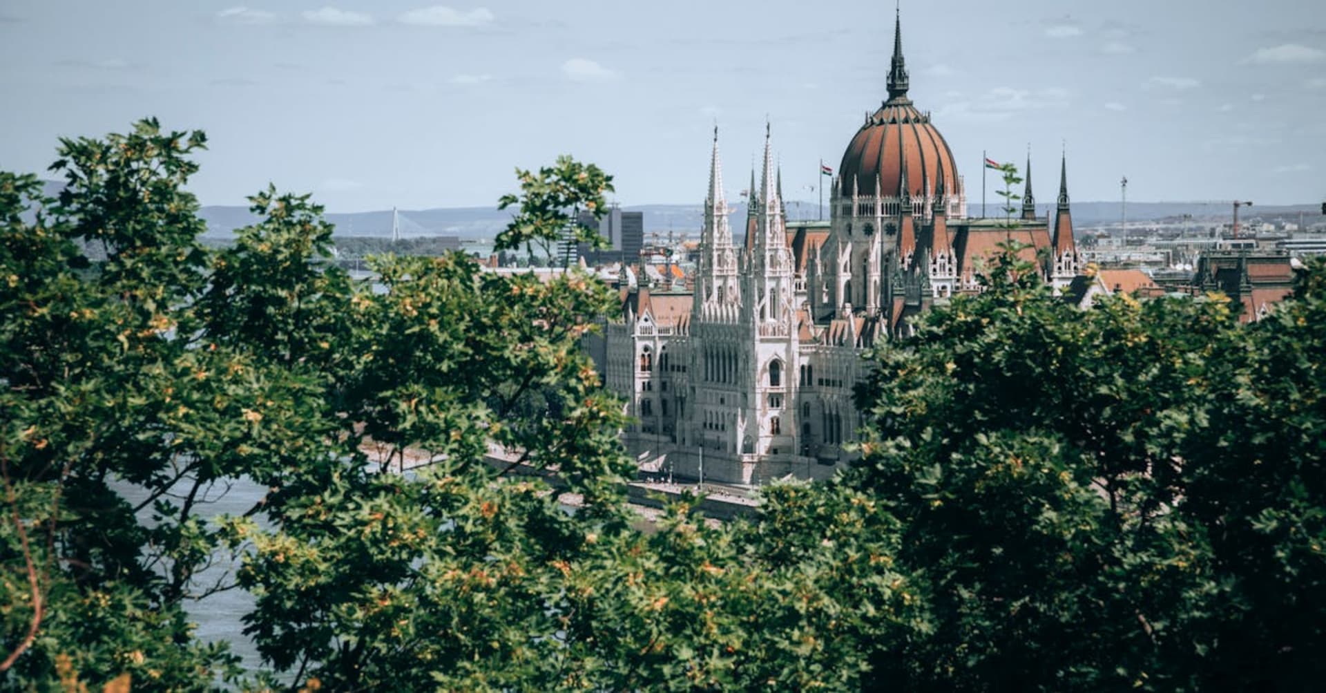 The Baroque minaret and castle ruins of Eger with vine-covered hills in the background