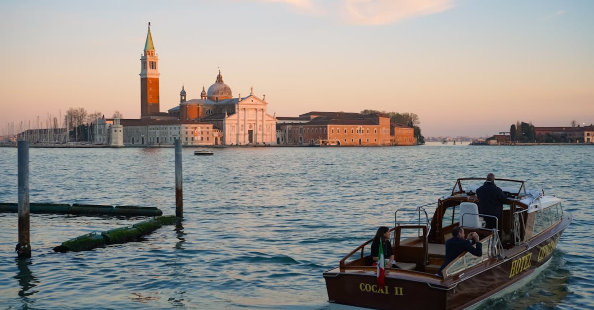 Milky blue geothermal water of the Blue Lagoon surrounded by dark volcanic rock and steam