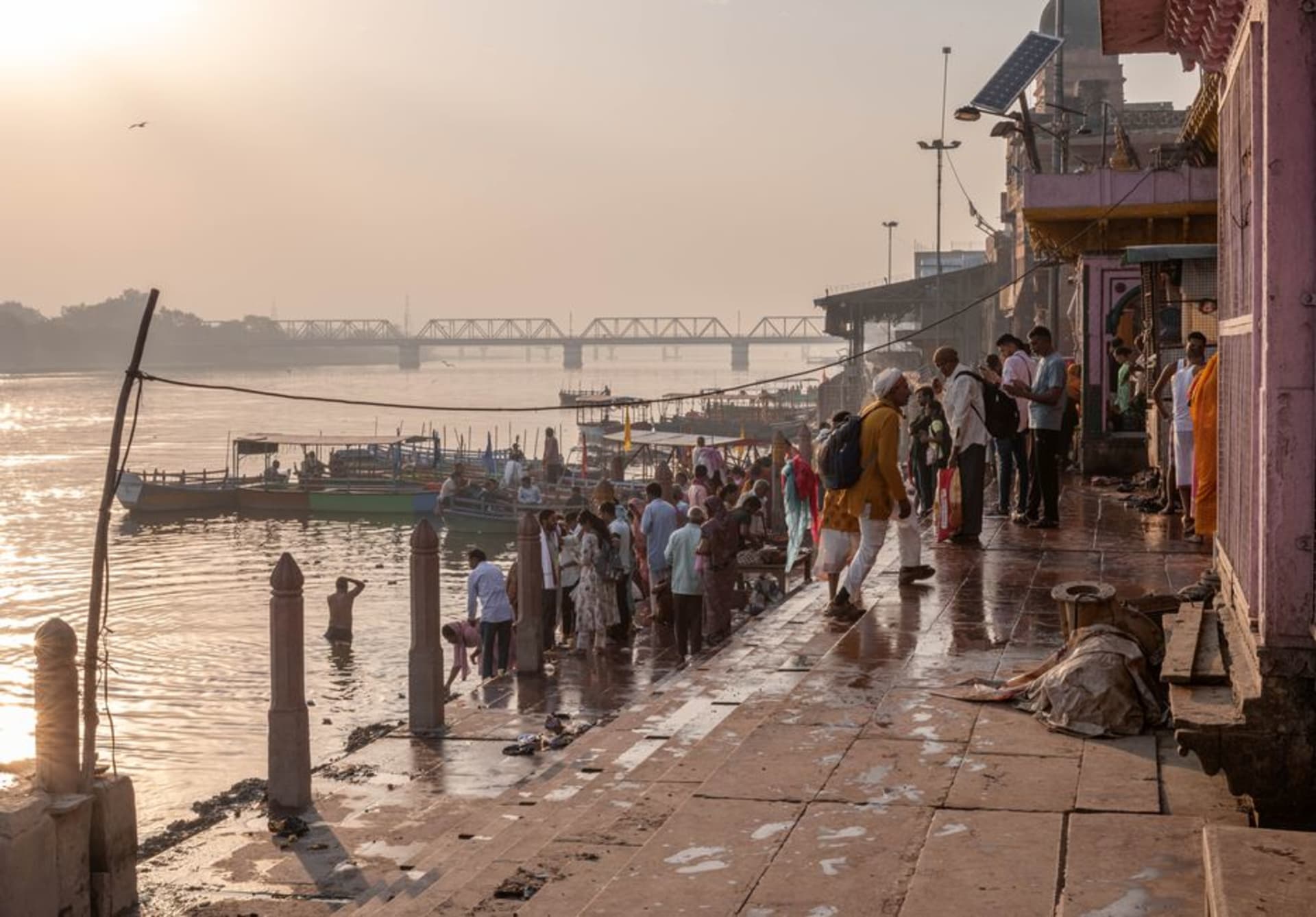 Stone ghats lining the Mandakini River at Chitrakoot with pilgrims bathing at dusk