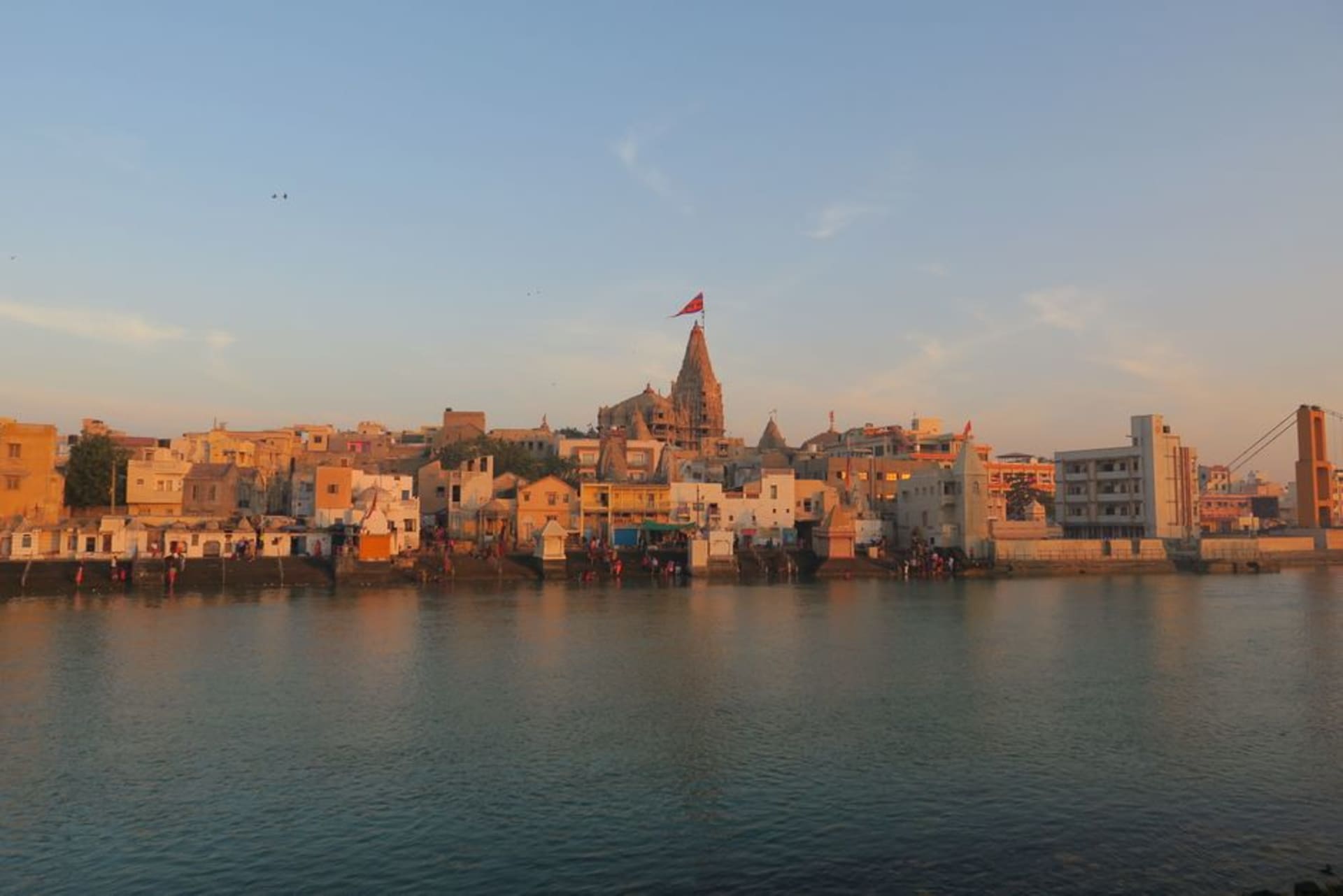 The tall carved shikhara tower of Dwarkadhish Temple rising above Dwarka's rooftops