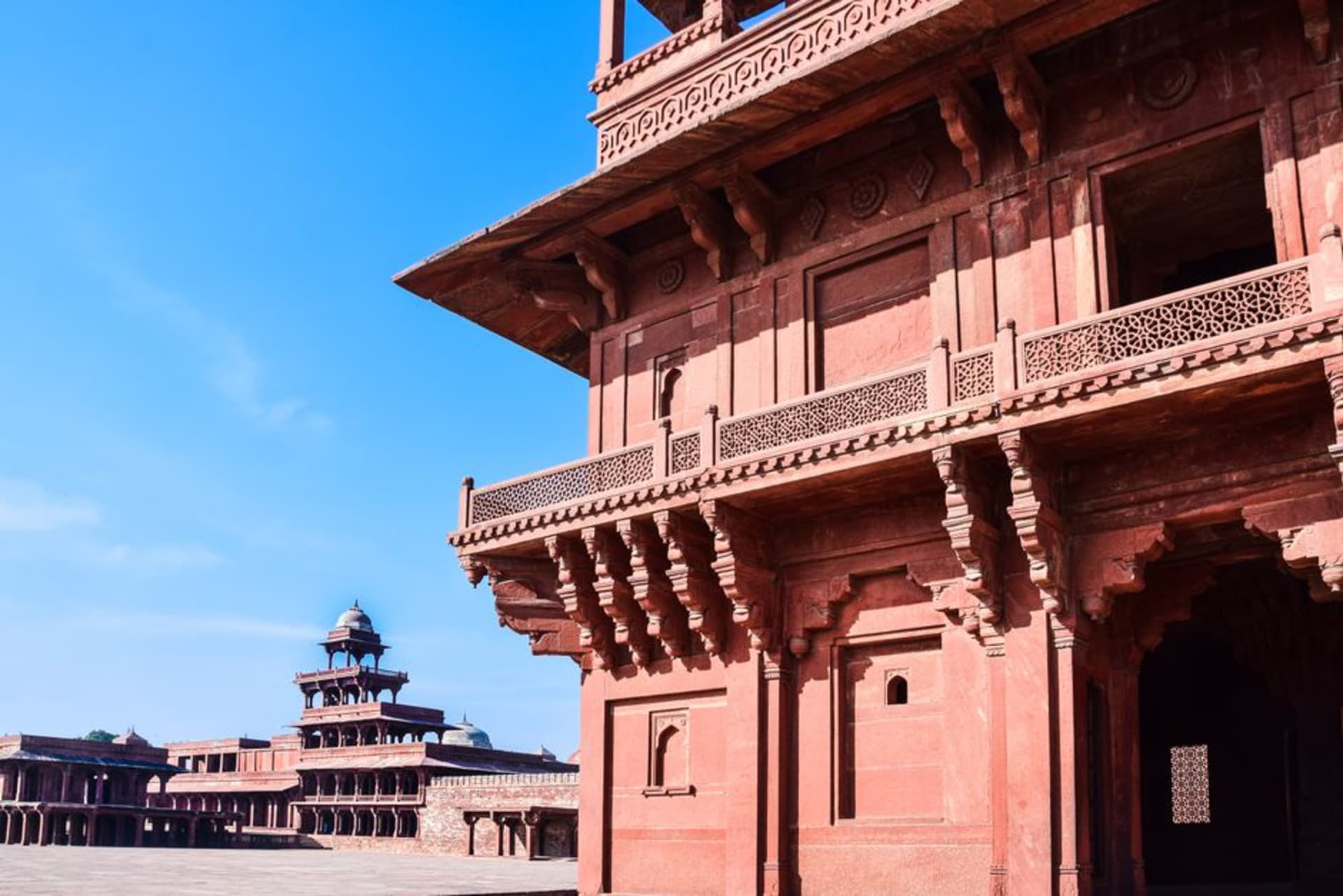 The red sandstone courtyards of Fatehpur Sikri glowing under the afternoon sun