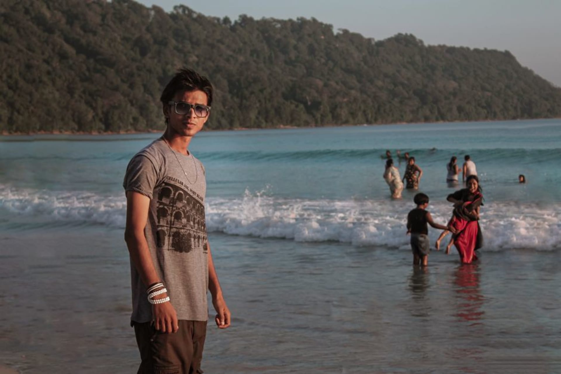 Radhanagar Beach at sunset with turquoise water and dense forest behind the sand