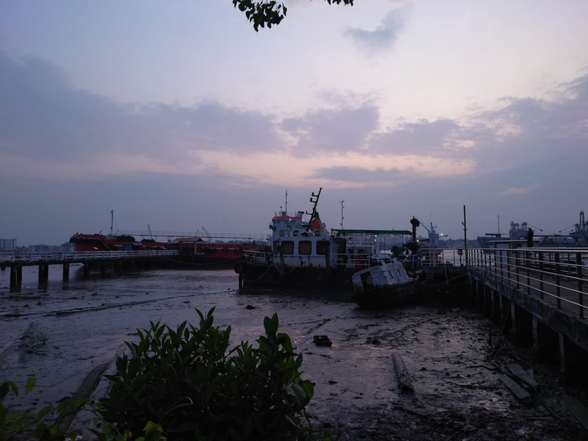 Giant cantilevered Chinese fishing nets silhouetted against the sunset at Fort Kochi
