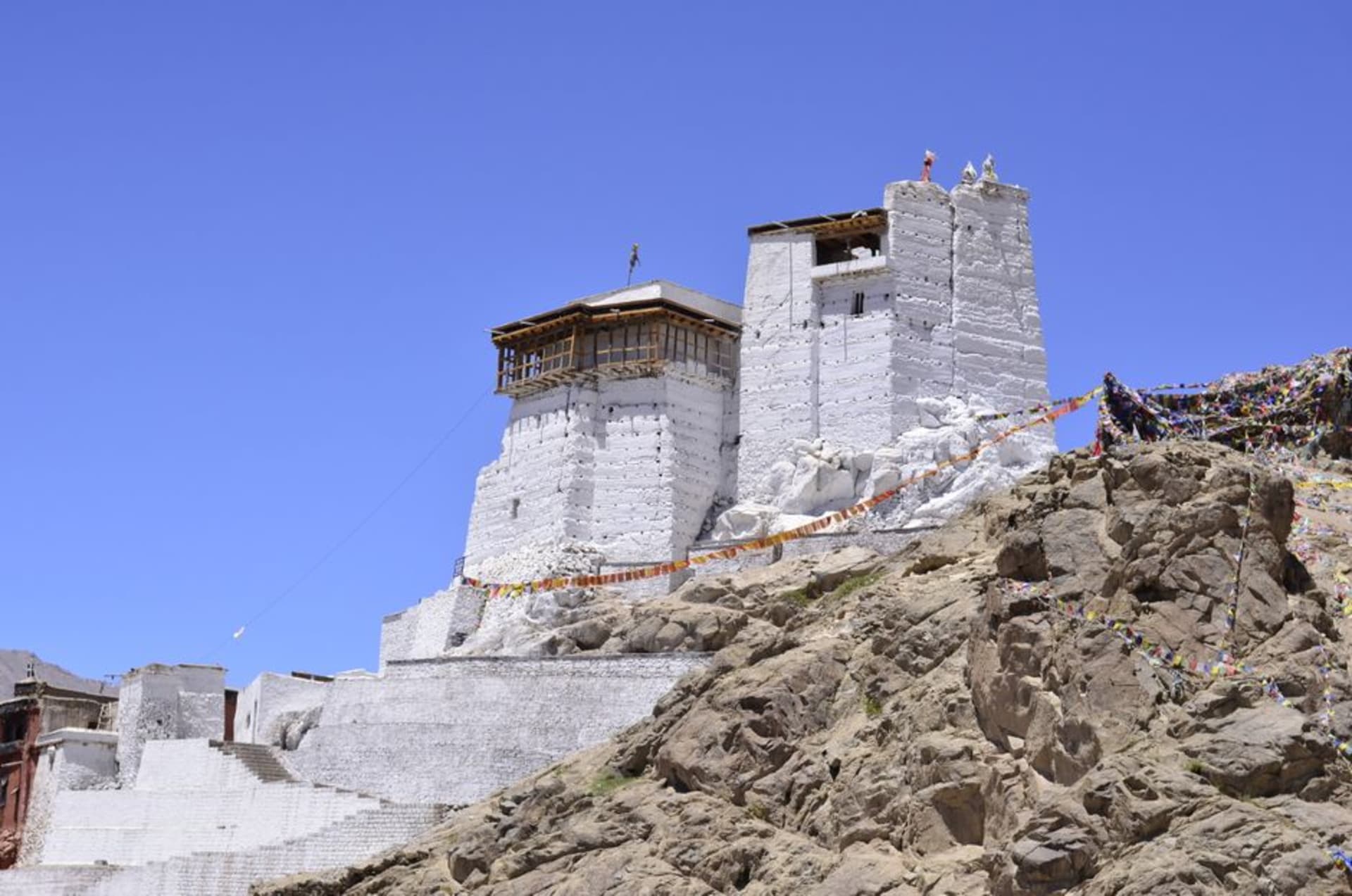 Leh Palace rising above the old town with barren mountains behind it