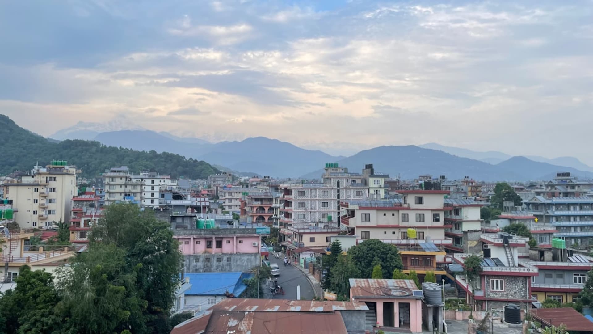 Colonial-era buildings and pine forest along the ridge of Shimla at dusk