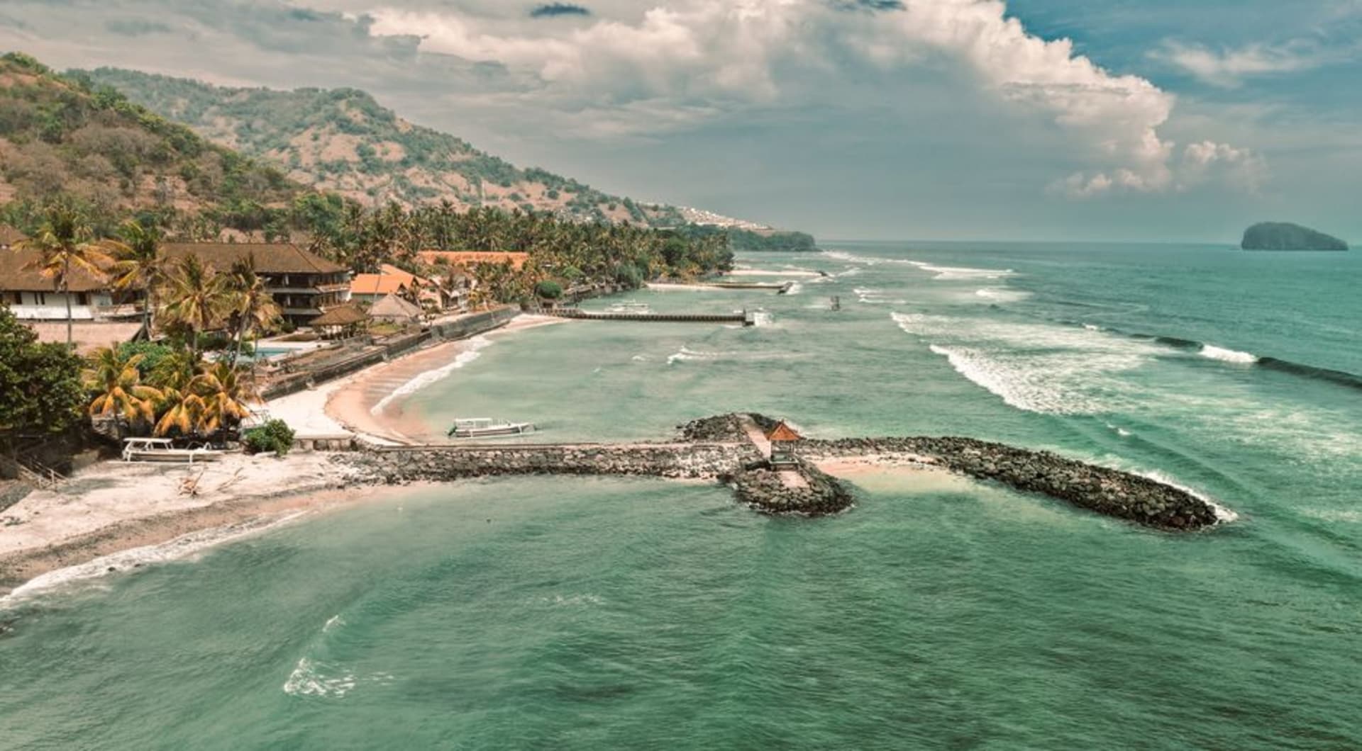Palm-lined coastline and calm sea at Candidasa, East Bali