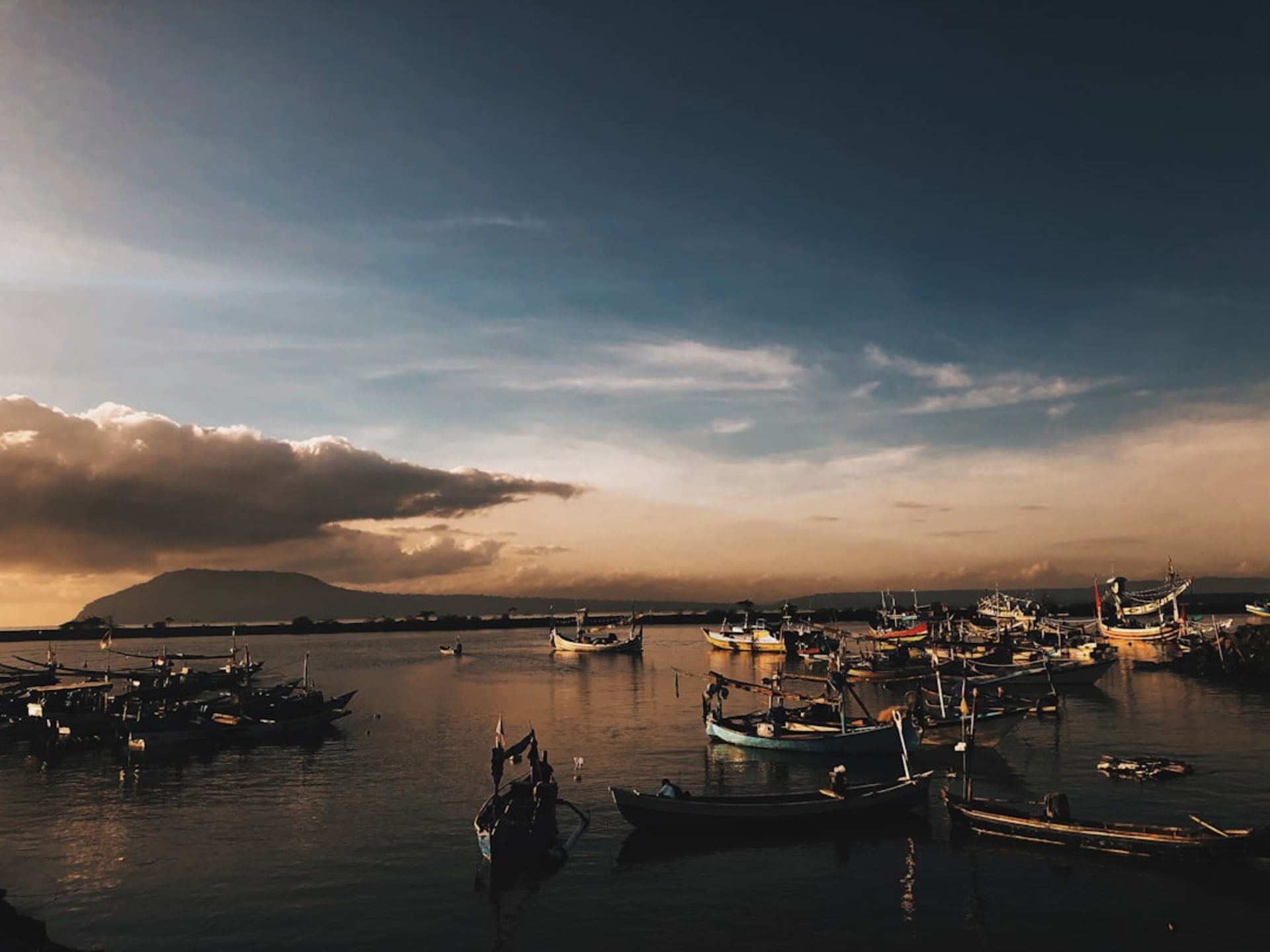 Coastal view near Banyuwangi with fishing boats and green hills