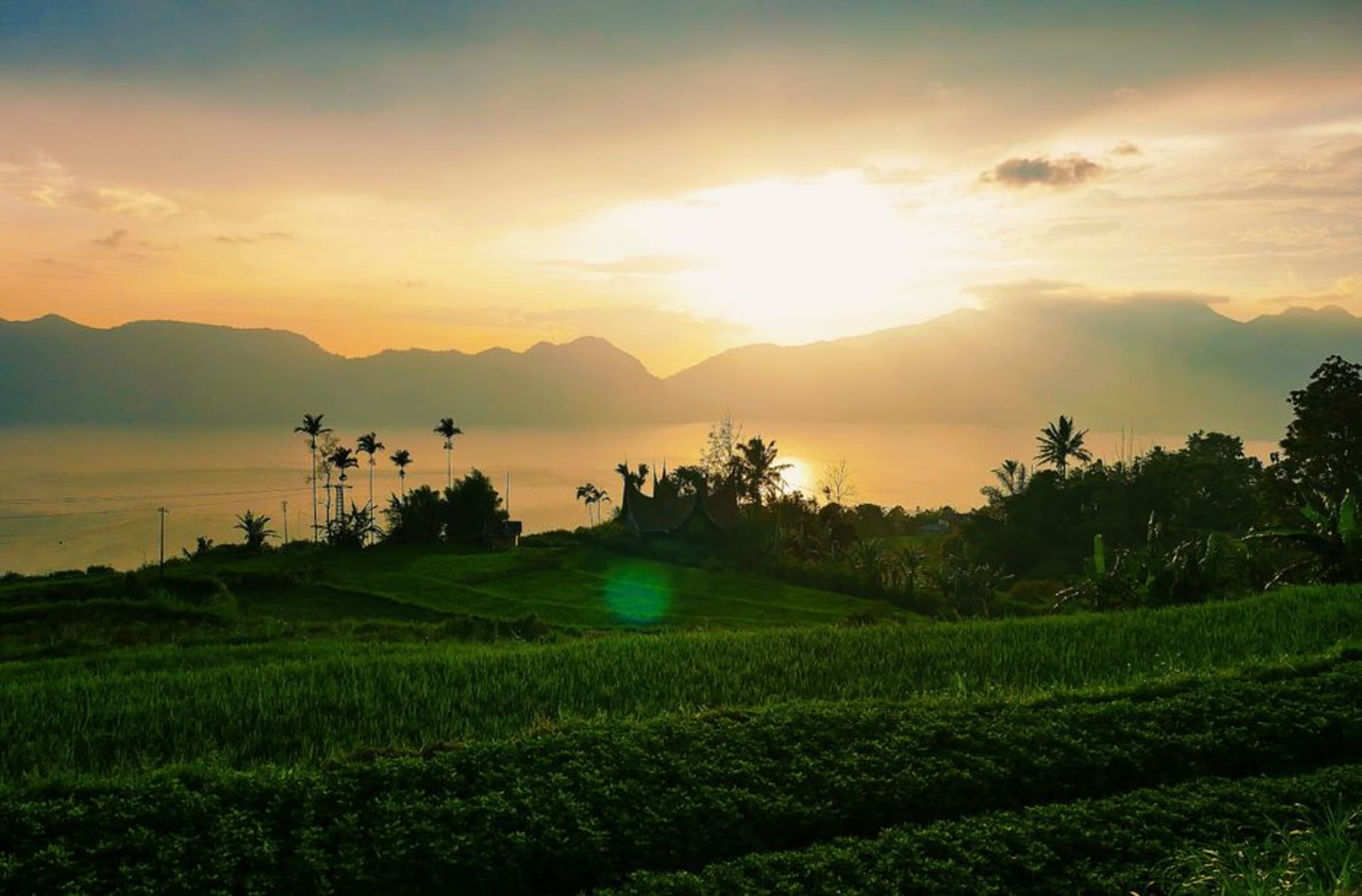 Danau Singkarak lake at golden hour with the surrounding West Sumatra hills