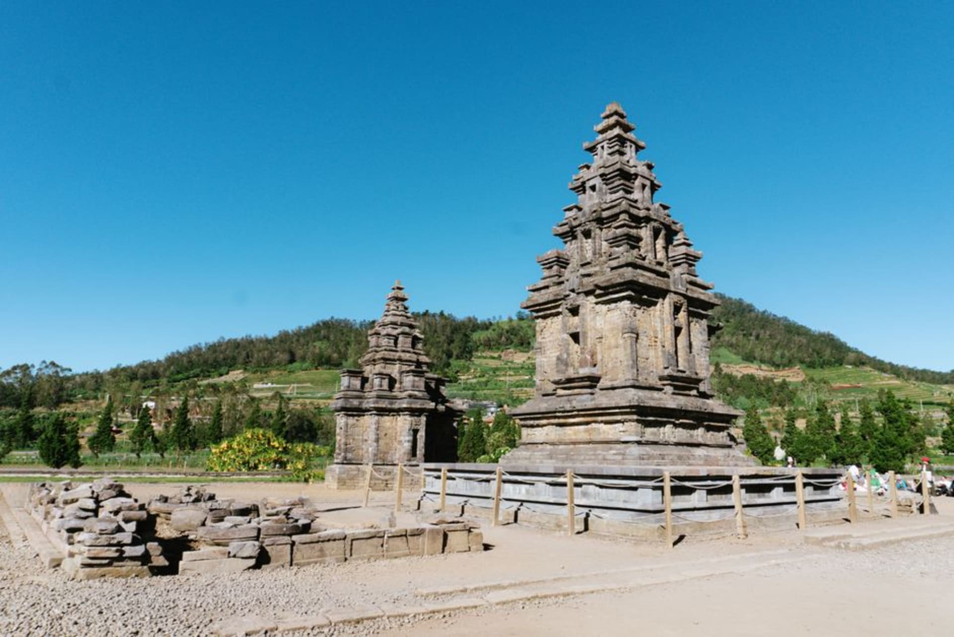 Ancient Hindu temples of the Arjuna Complex shrouded in morning mist on the Dieng Plateau