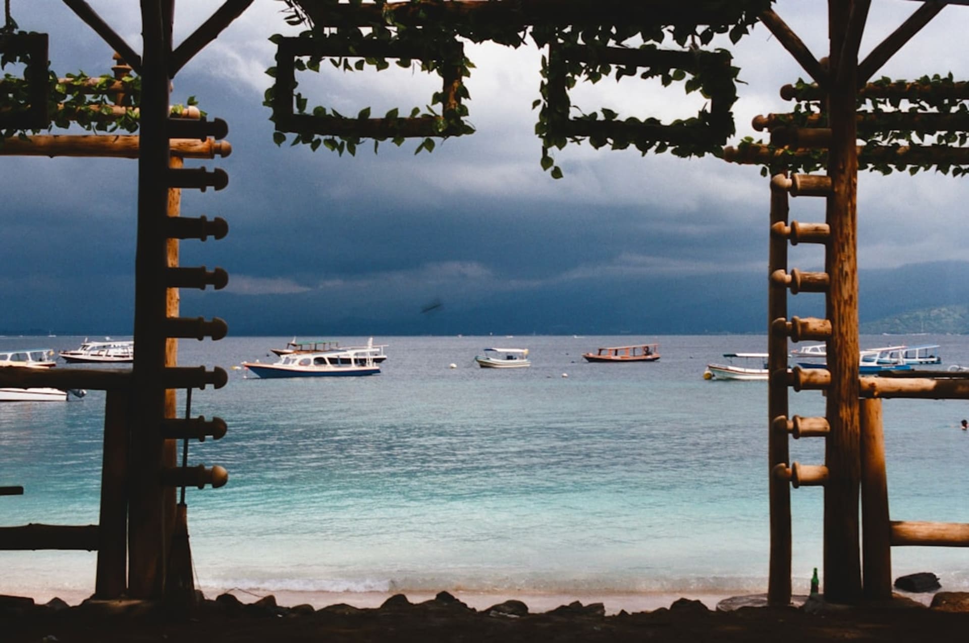 White sand beach and turquoise water on Gili Trawangan with traditional fishing boats