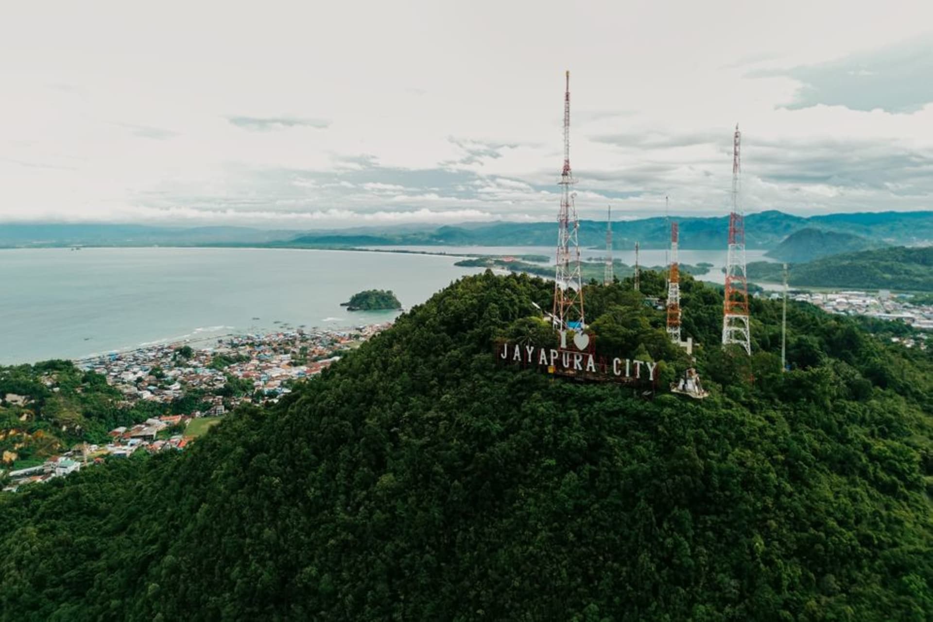 Jayapura city built along the hillsides of a deep blue harbor bay