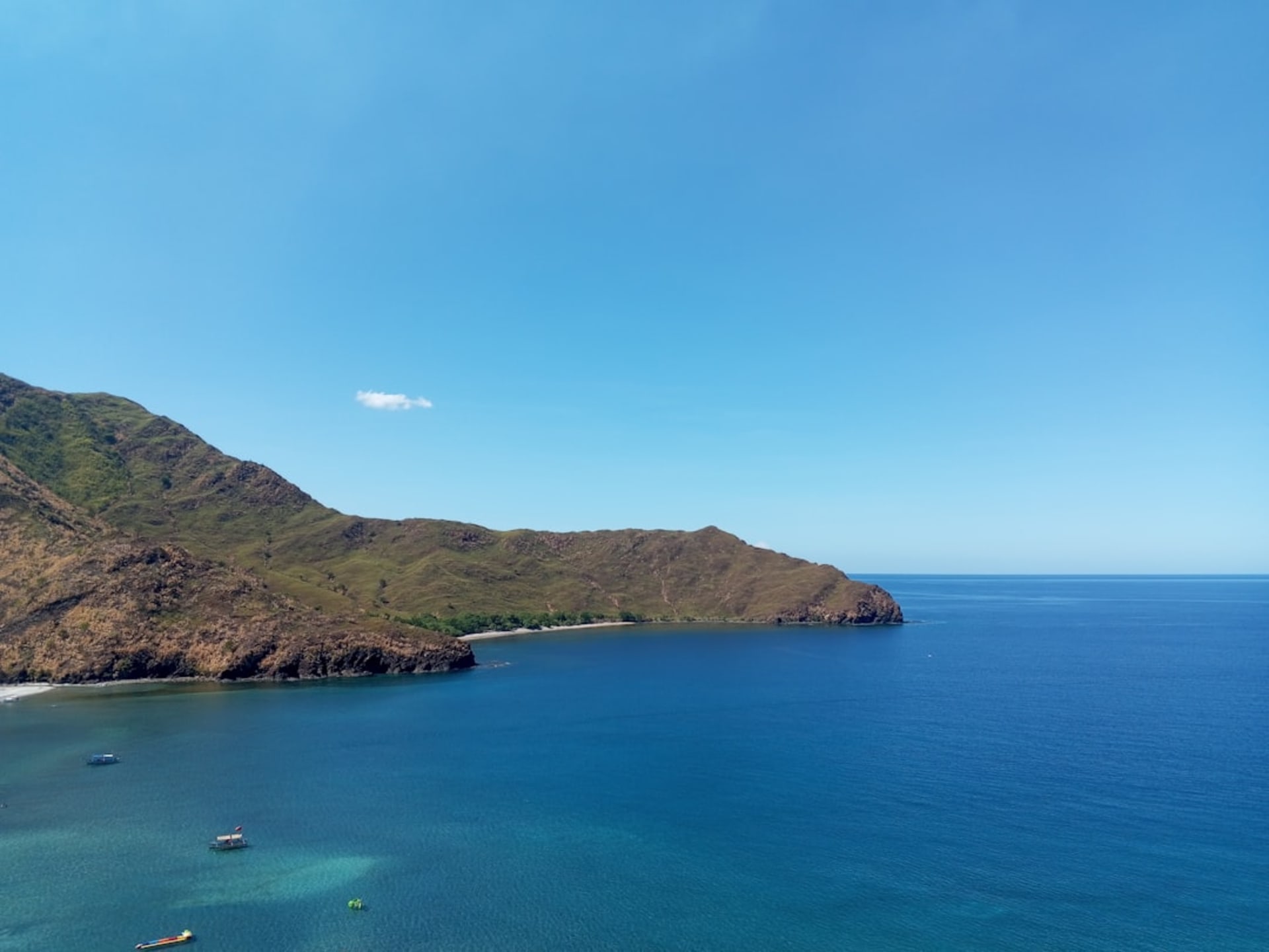 Crescent bay of Kuta Lombok with turquoise water and green hills