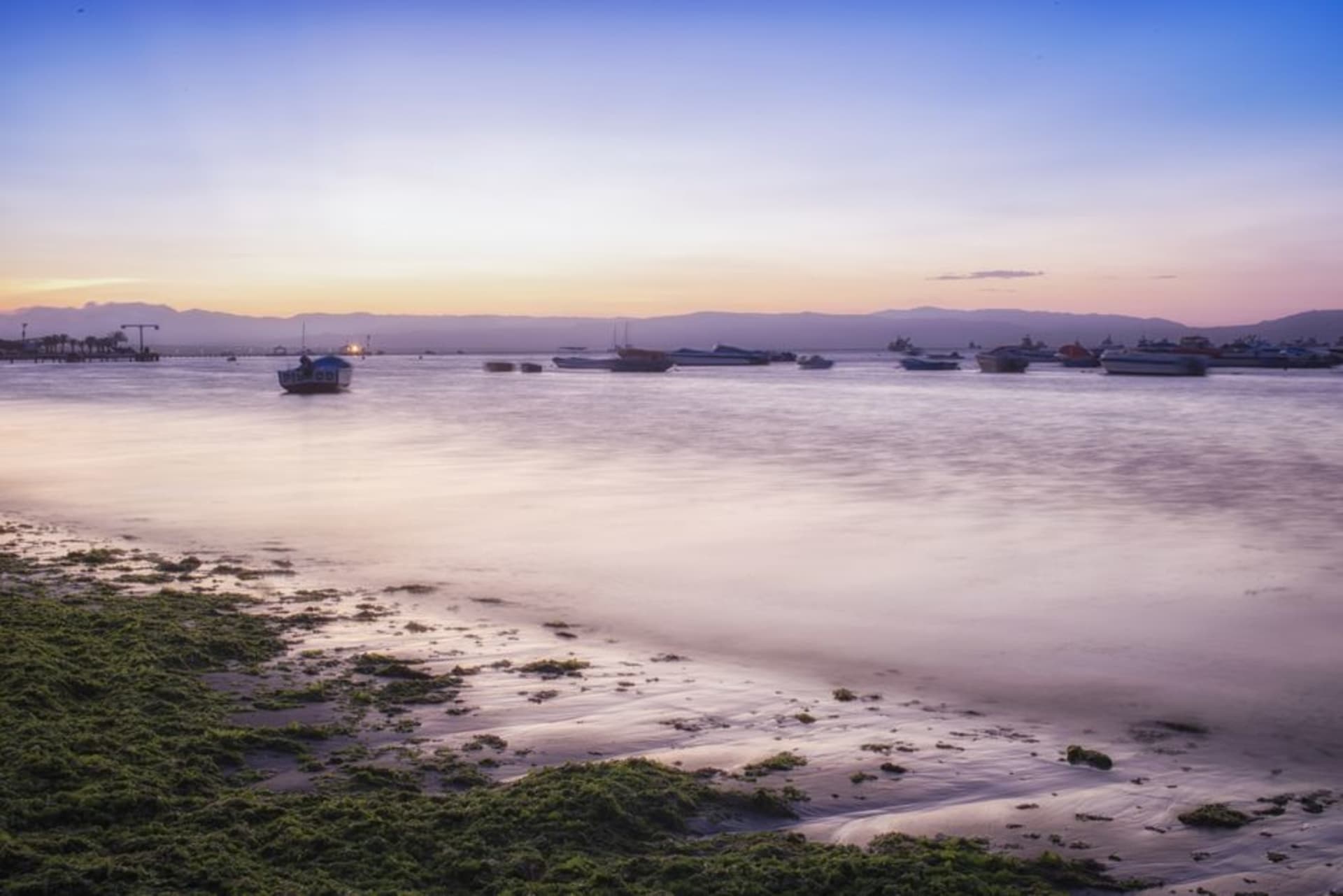 Fishing boats moored in the calm waters of Maumere Bay at sunrise