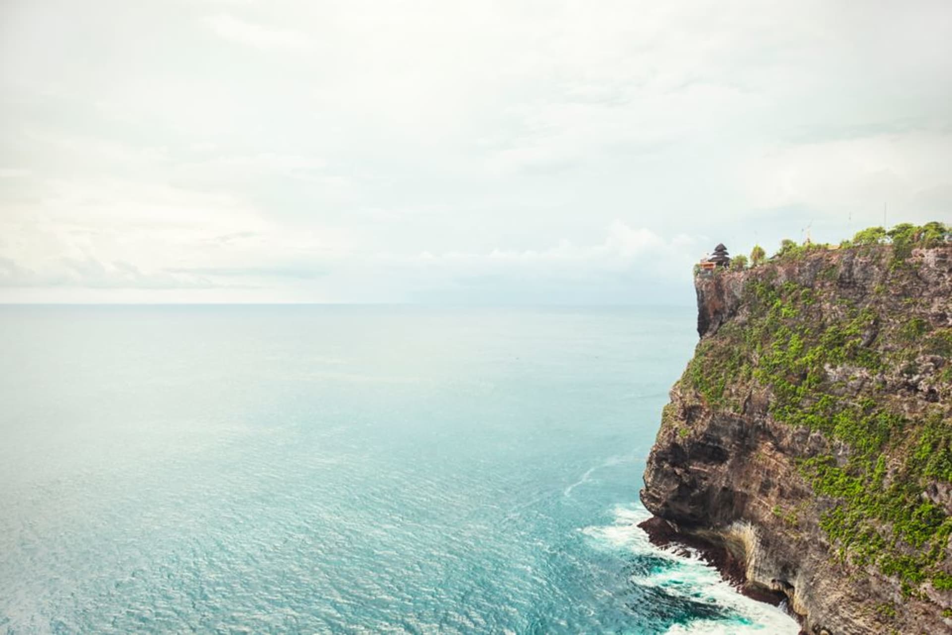 Pura Luhur Uluwatu temple perched on a dramatic limestone cliff above the ocean