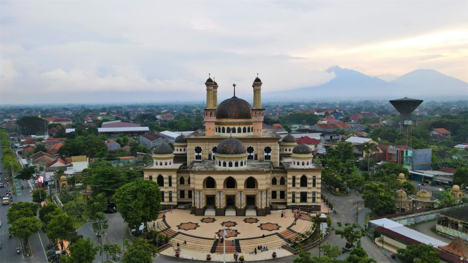 Grand Mosque of Medan with its black domes against a hazy tropical sky